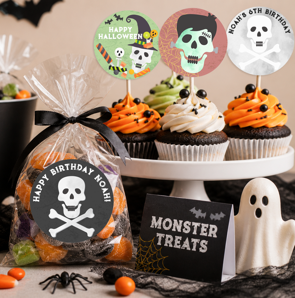 Halloween birthday dessert table featuring cupcakes with themed toppers, a clear candy favor bag with a skull sticker, and spooky decorations including a ghost figurine and “Monster Treats” sign.