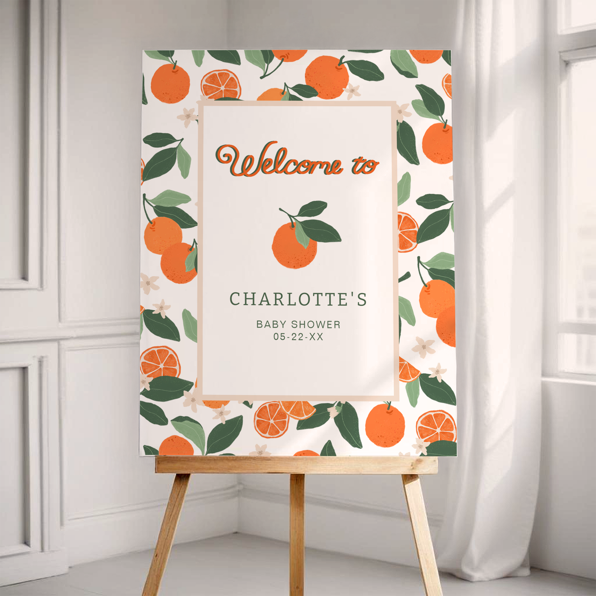 Little Cutie baby shower welcome sign displayed on an easel with clementine illustrations and soft botanical border.