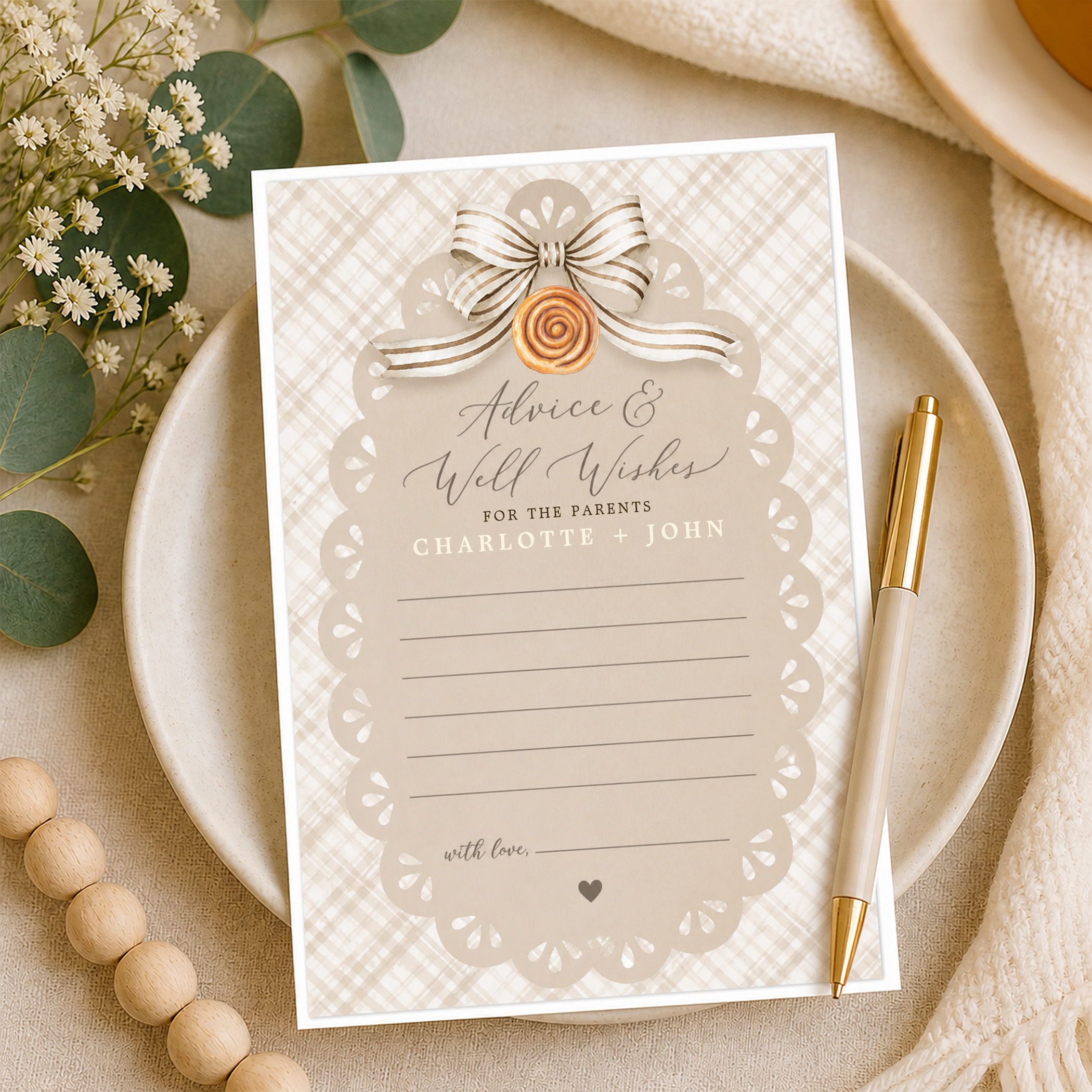 Neutral “Advice & Well Wishes” baby shower card with gingham pattern and bow detail, styled on a plate with florals and pen for guests to write messages.
