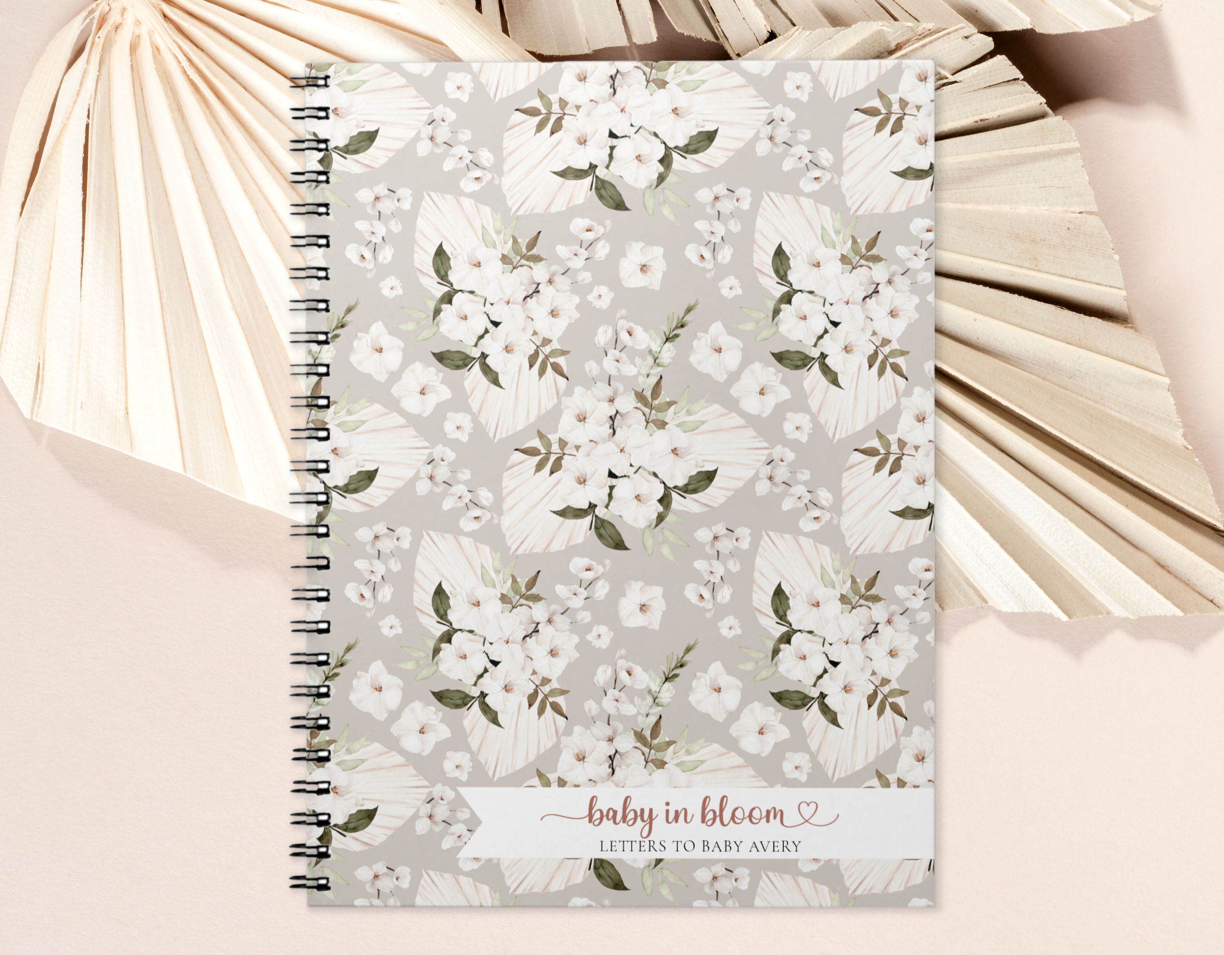 Floral "Letters to Baby" keepsake guest book displayed on a neutral background with palm leaves in a soft editorial style.