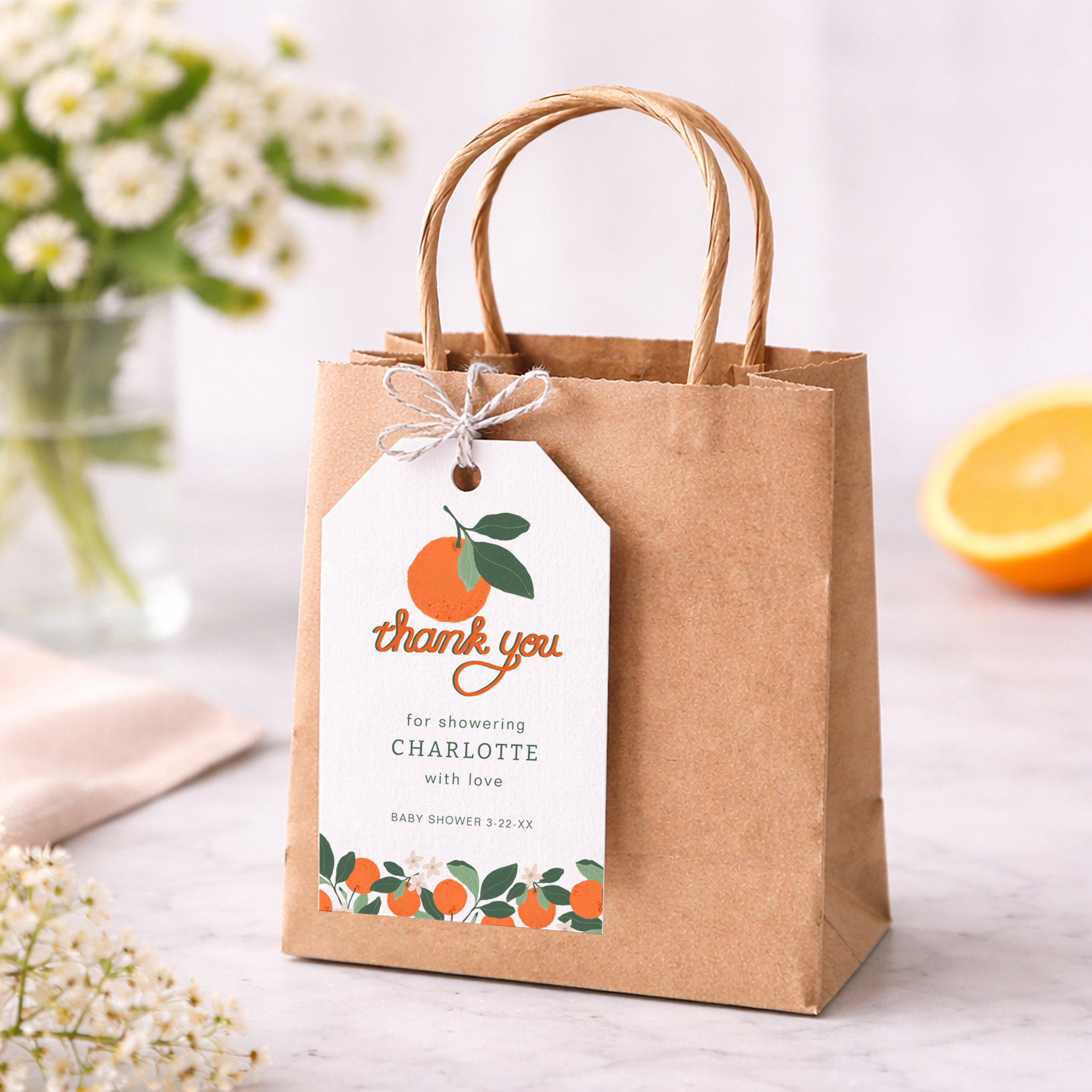Little Cutie baby shower favor bag with a personalized thank you tag tied to the handle using twine