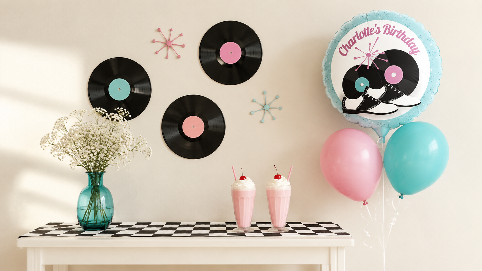 Simple 1950s sock hop décor with vinyl records, milkshakes, flowers, and a personalized birthday balloon.