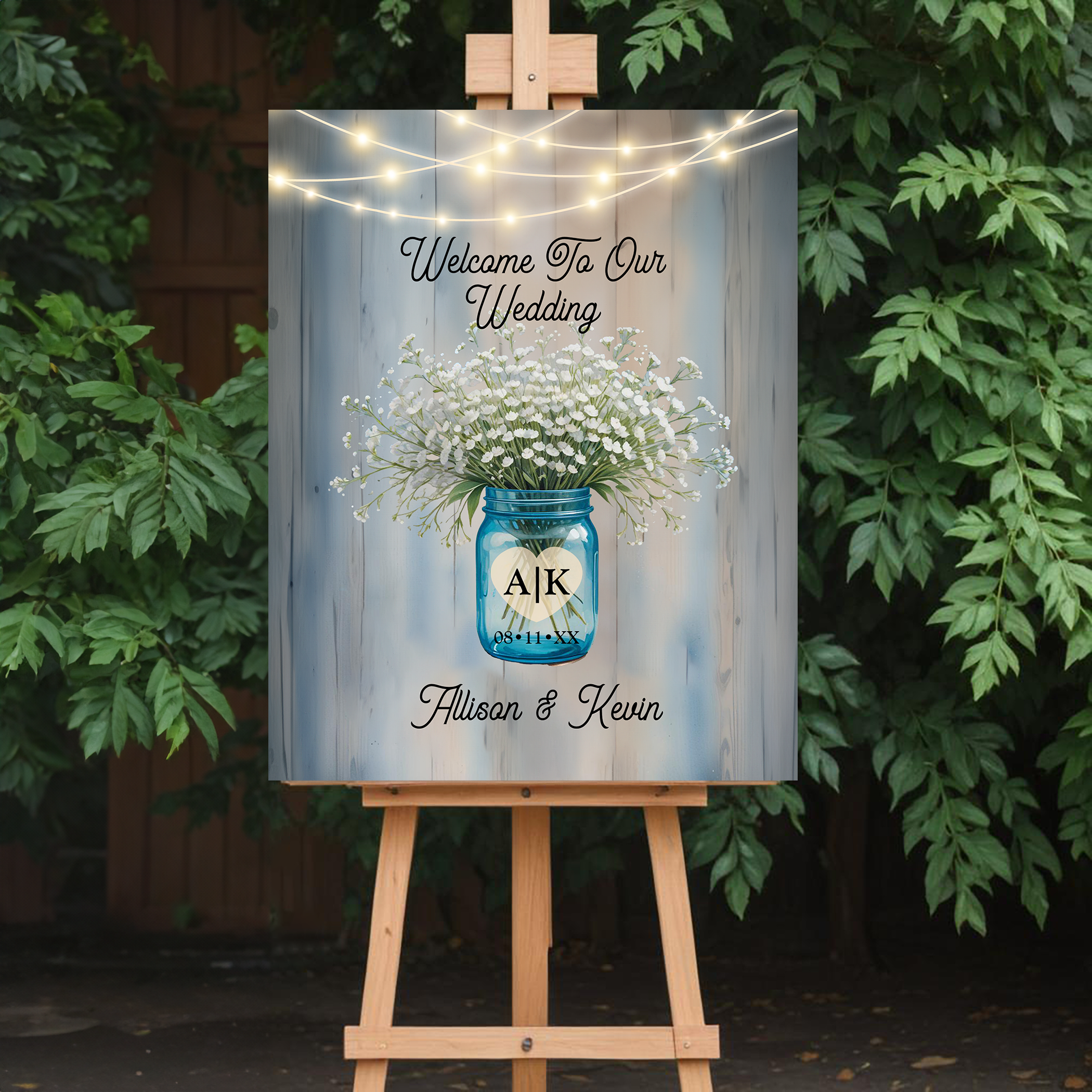 Rustic baby’s breath wedding welcome sign displayed on easel outdoors