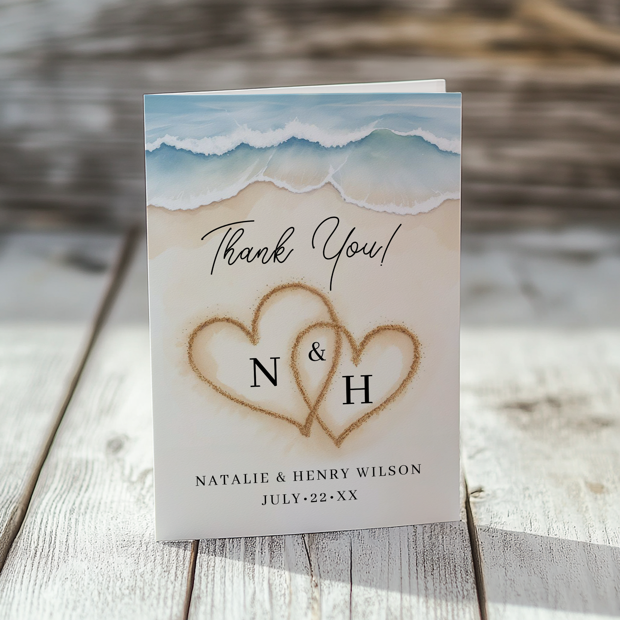 Beach wedding thank you card with watercolor waves and romantic sand hearts