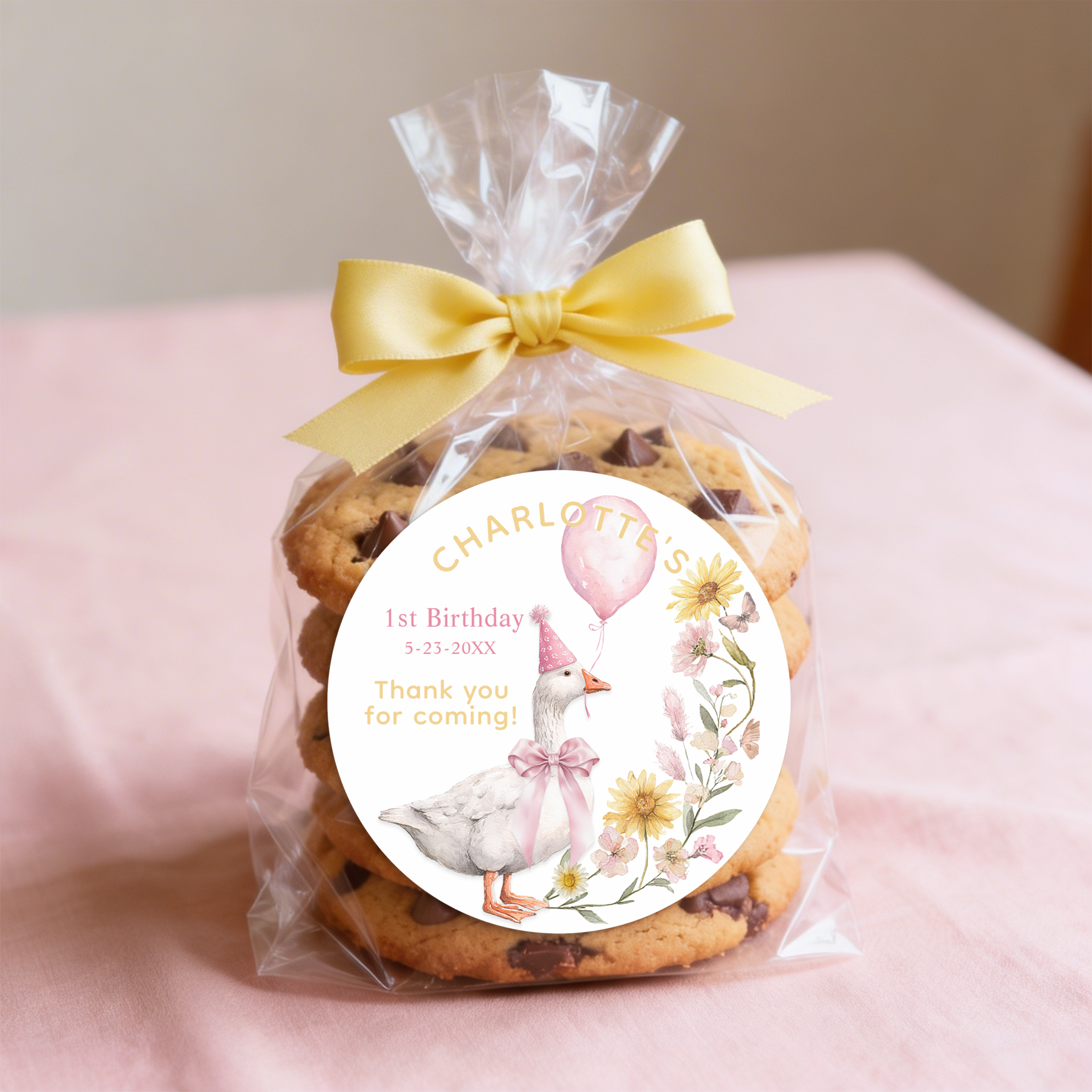 One Silly Goose 1st birthday favor sticker displayed on a treat bag with pink ribbon for a coordinated party look.
