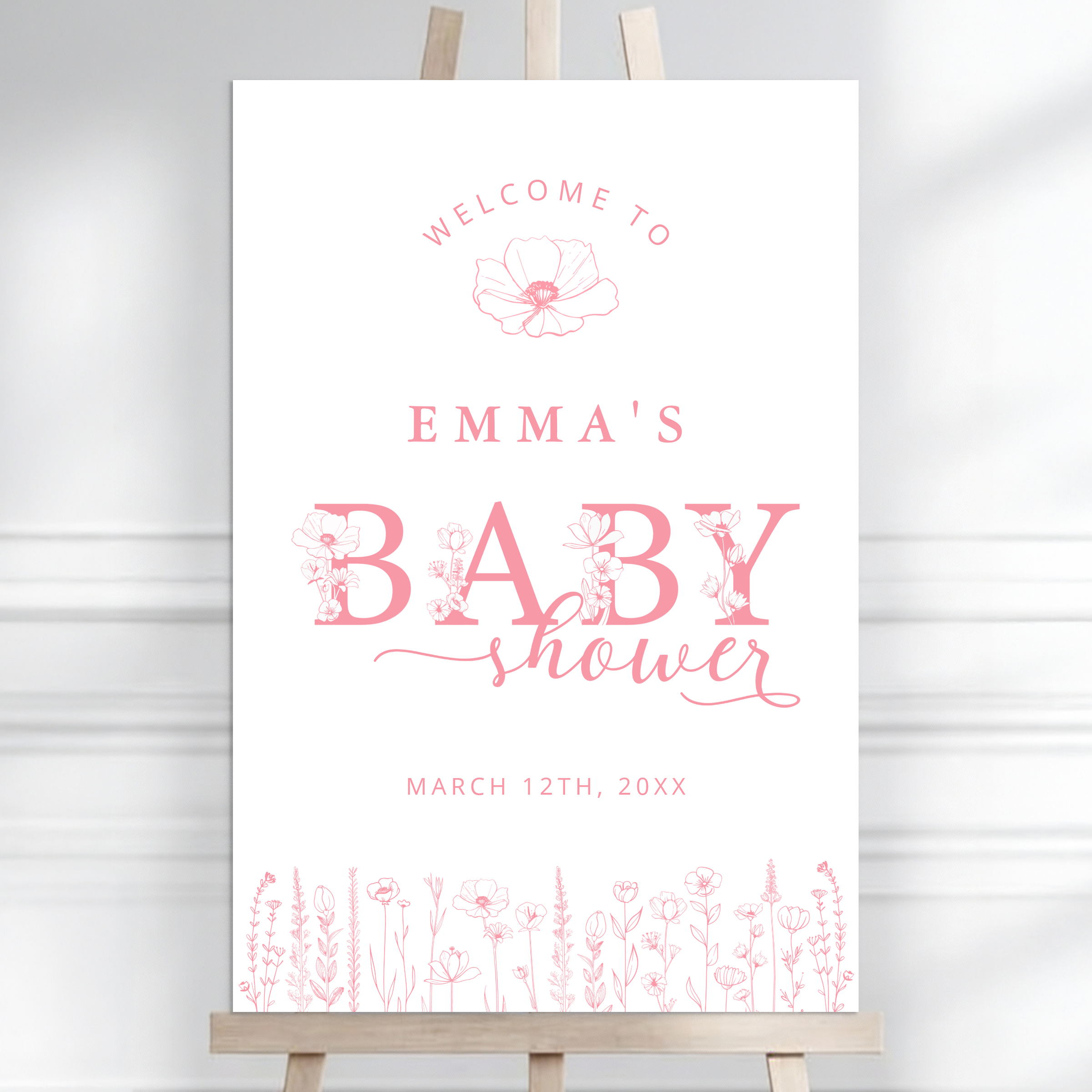 Dusty pink wildflower baby shower welcome sign on easel with soft floral border and romantic design.