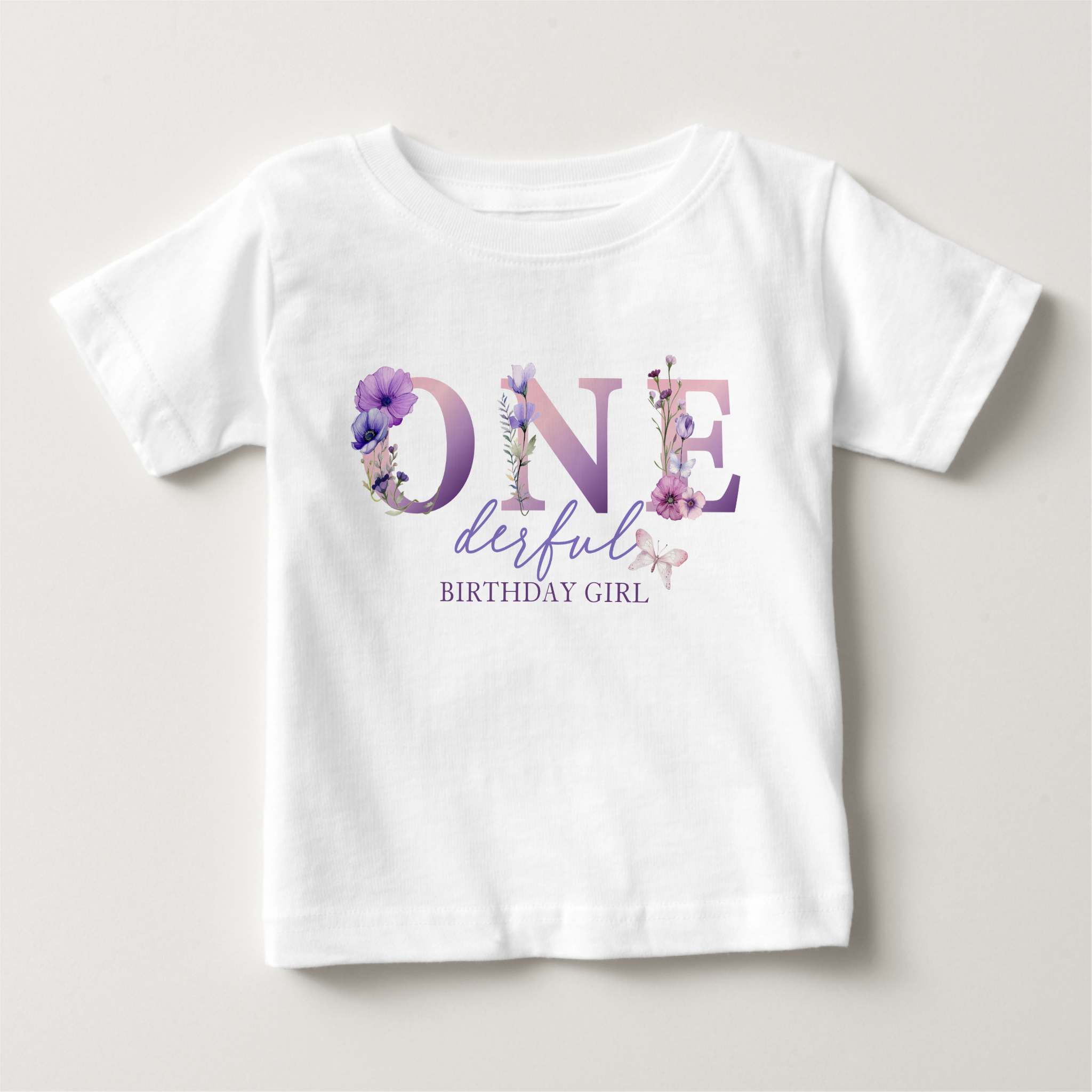 ONEderful birthday girl t-shirt with purple wildflower lettering and soft floral accents on a white shirt.