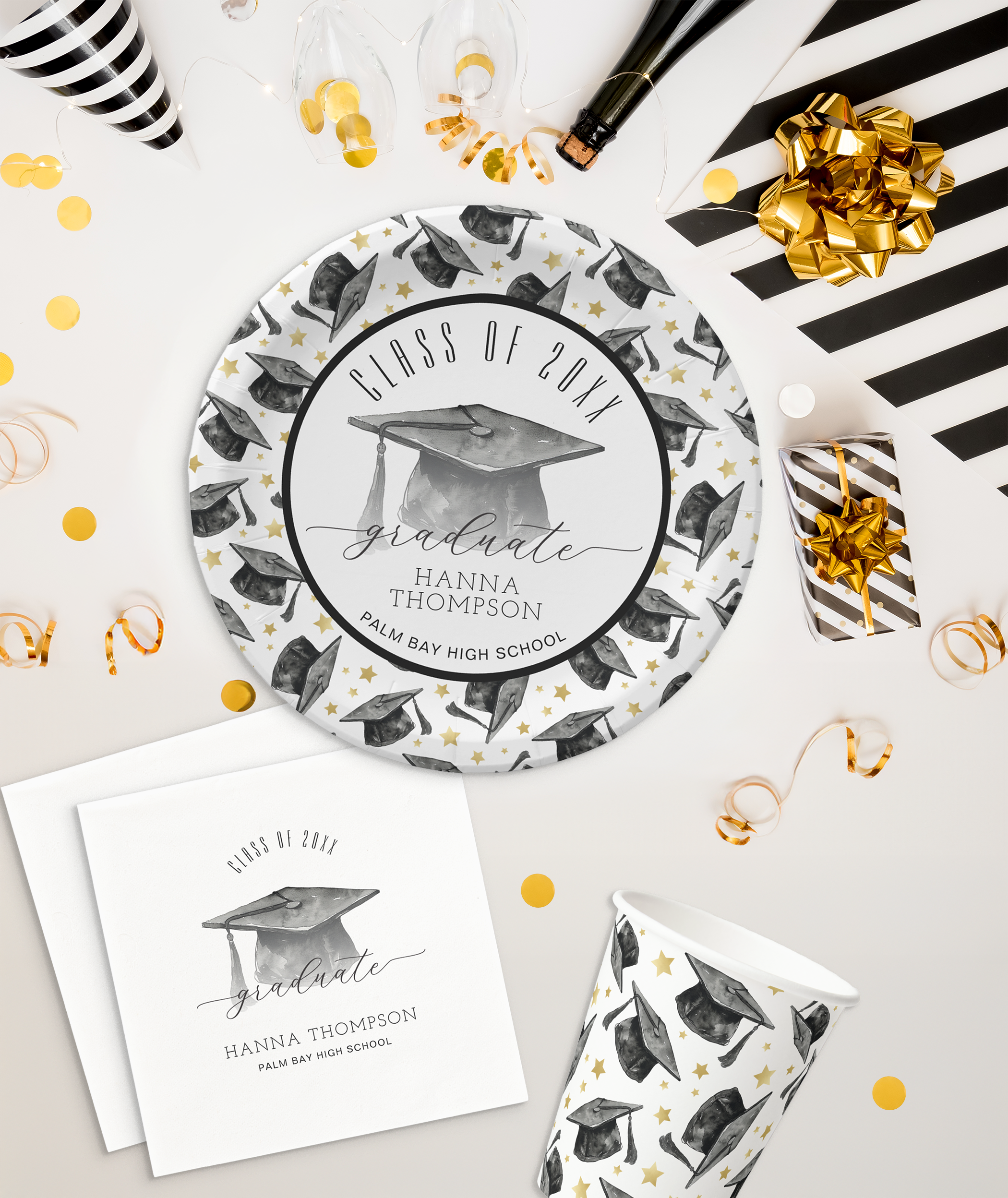 Graduation party paper plates featuring black graduation caps and gold stars, napkins and paper cups