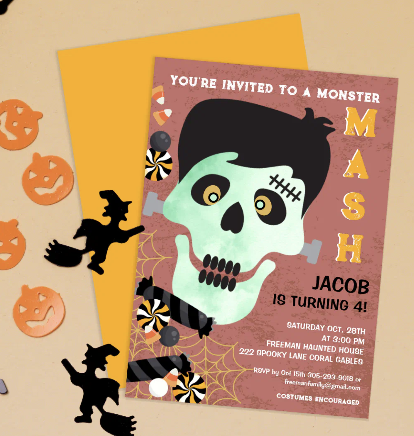 Monster Mash Halloween birthday invitation featuring a playful skull design with candy accents, styled with an orange envelope and spooky cutouts on a neutral background.