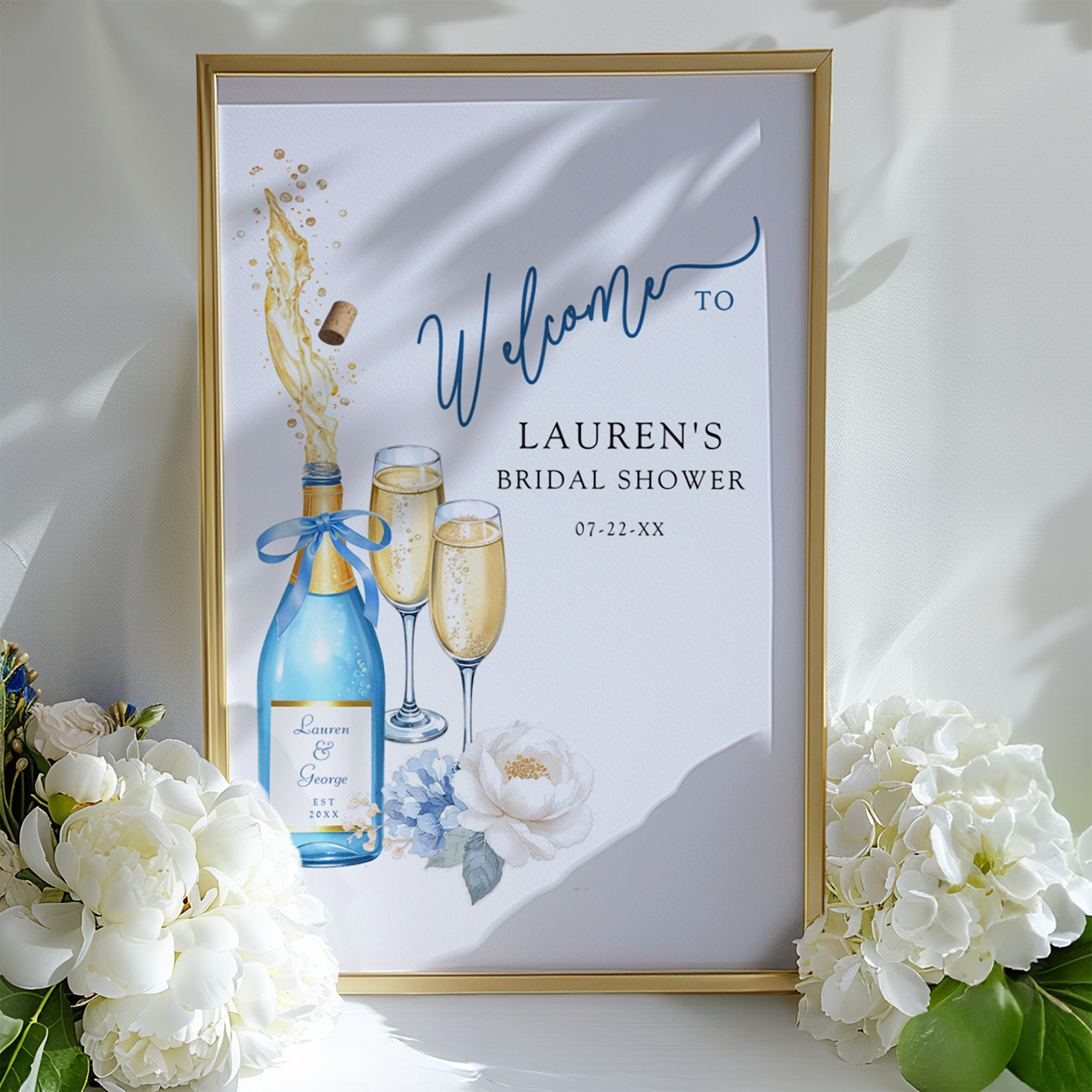 Large bridal shower welcome sign featuring champagne bottle and flutes with soft blue florals and elegant typography