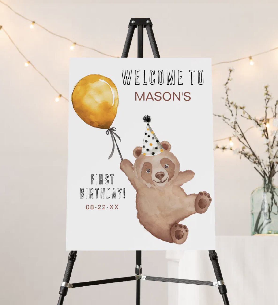 Teddy bear birthday welcome sign with watercolor bear holding balloon and festive confetti details.