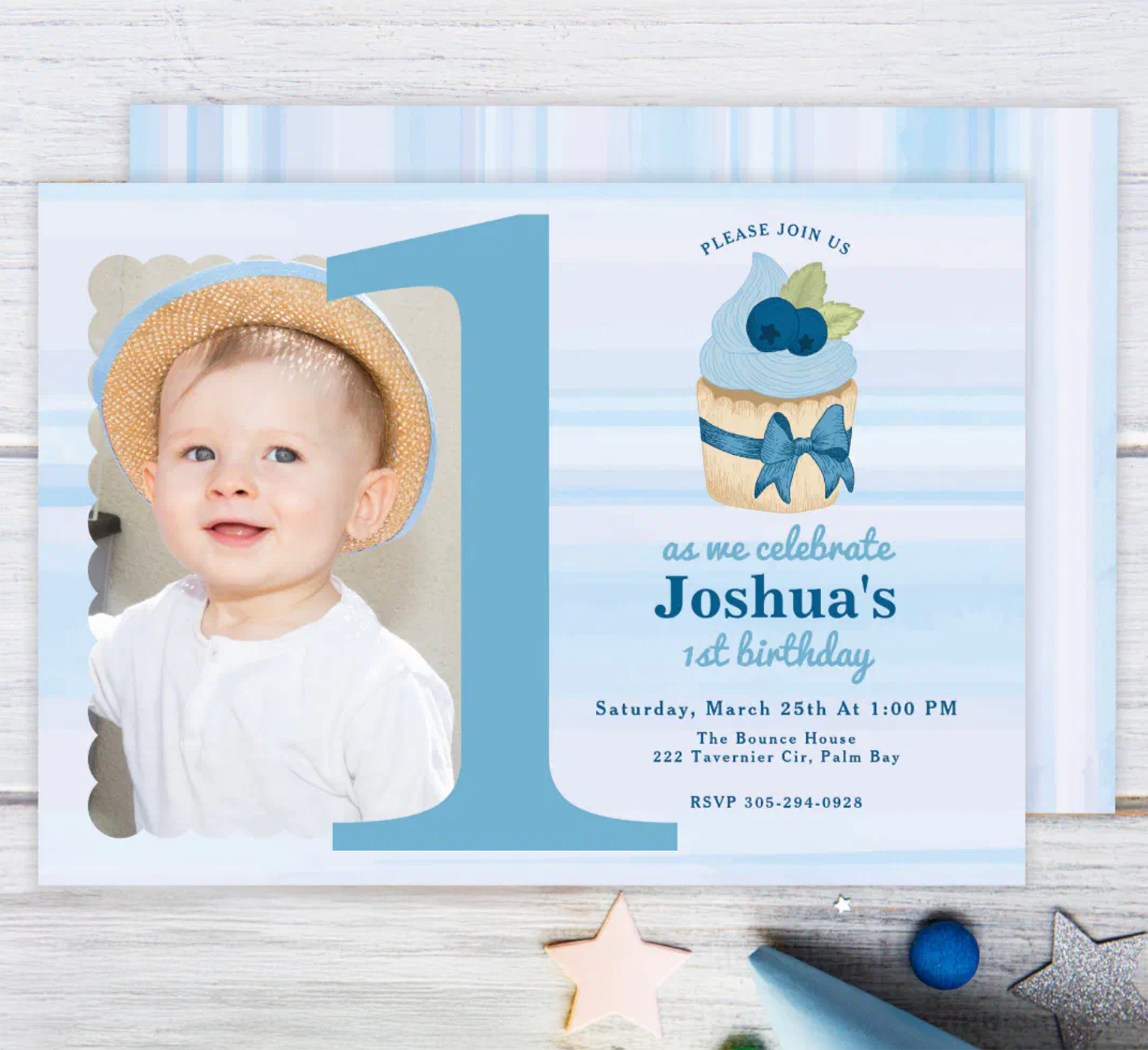 Baby boy first birthday photo invitation with large number one and cupcake theme.