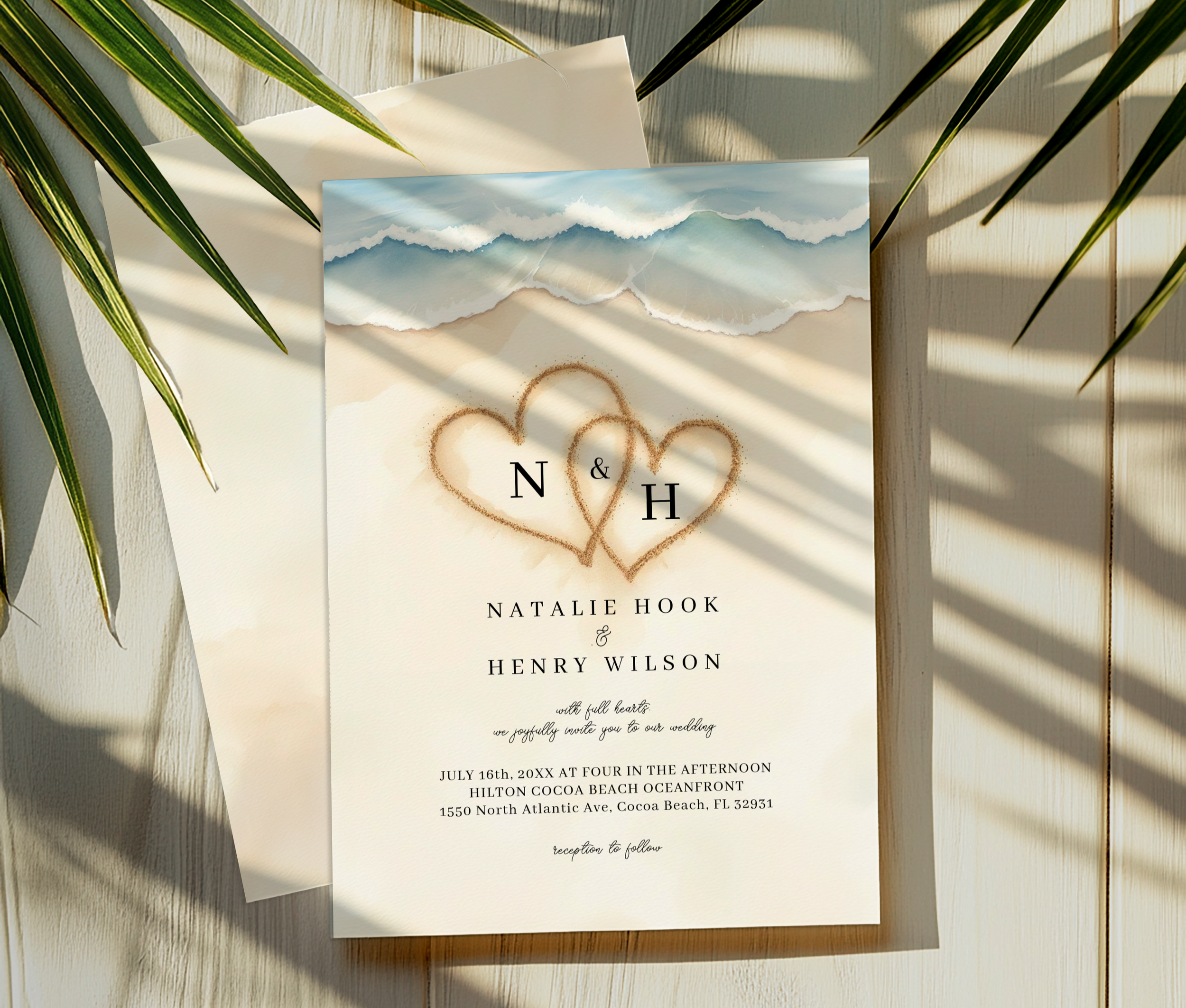 Watercolor beach wedding invitation with ocean waves and sand heart monogram