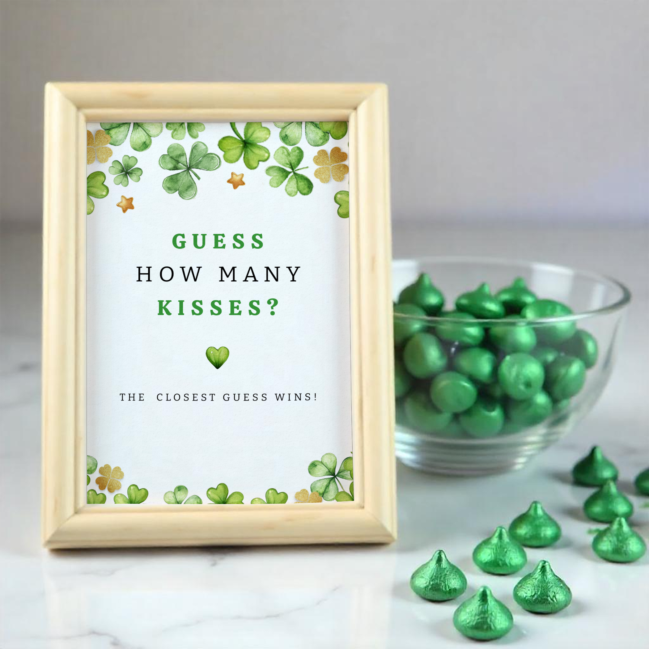 Lucky Charm baby shower favor bag filled with caramel popcorn, tied with a gold ribbon, and finished with a personalized clover thank-you sticker.