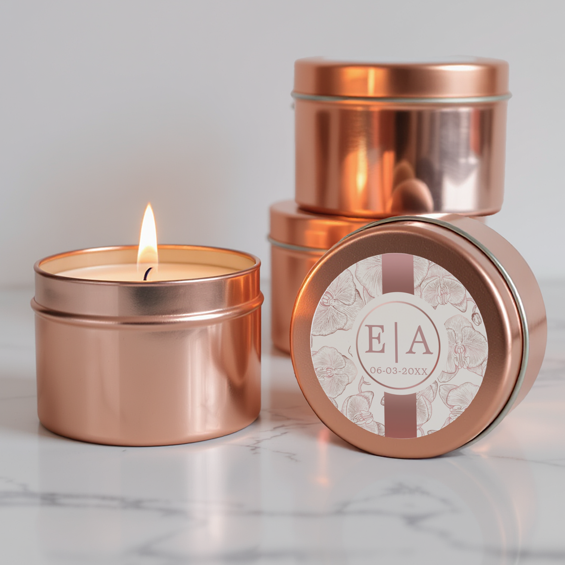 Round orchid monogram wedding favor sticker on a rose gold candle tin.