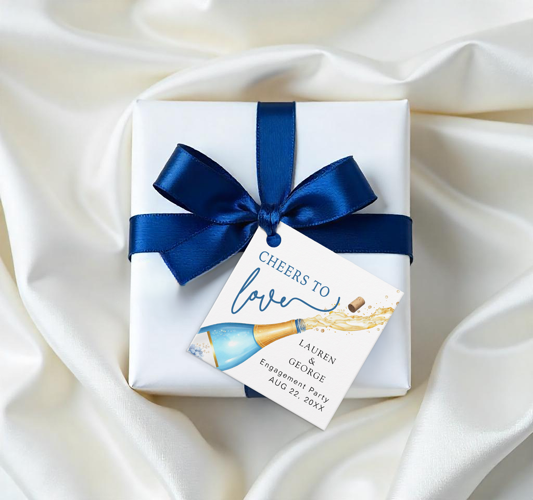 Personalized engagement party favor tag attached to a wrapped gift, featuring champagne bottle artwork and “Cheers to Love” text.