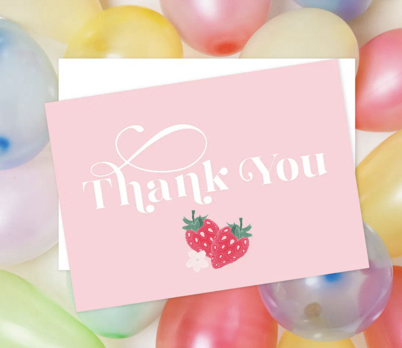 Strawberry patterned birthday party tableware including paper cups, plates, napkins, and cocktail napkins for a Berry First Birthday theme.