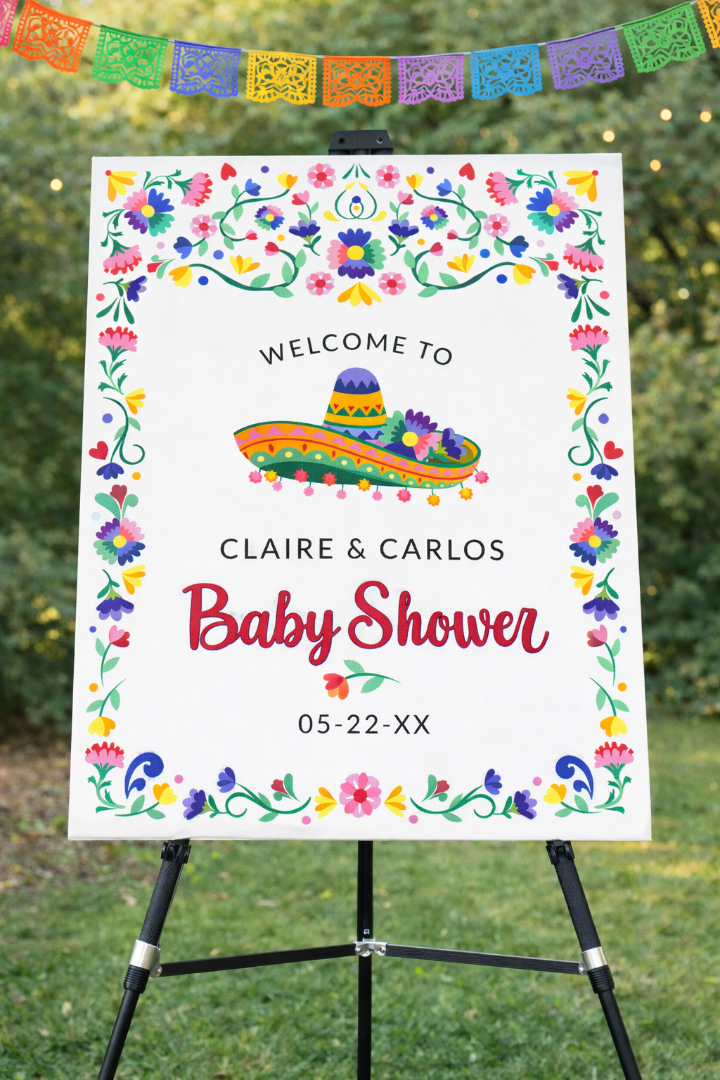 Fiesta baby shower welcome sign with colorful floral border and festive design displayed at entrance.