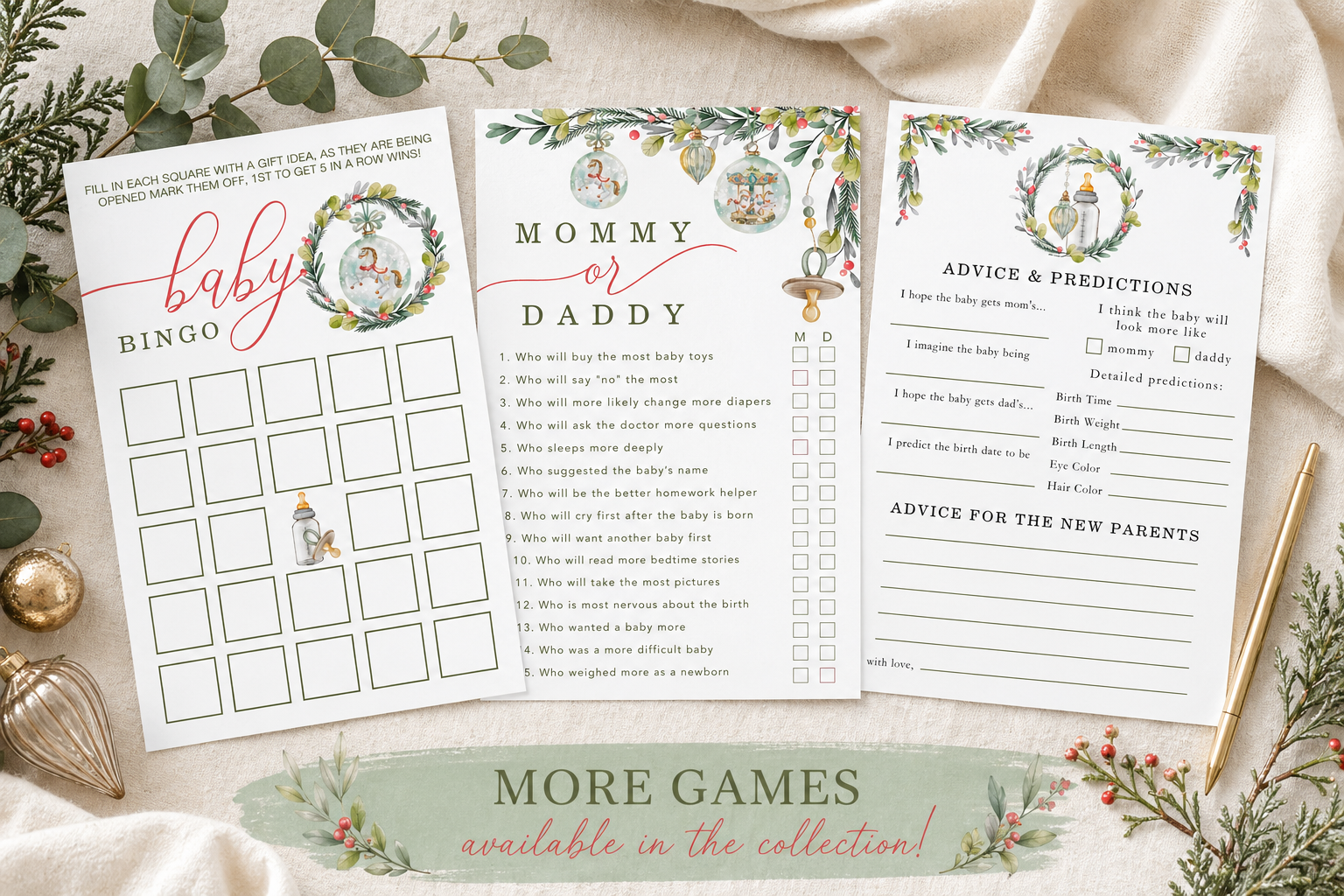 Flat lay of three Merry Little Christmas baby shower game cards arranged on soft cream fabric with winter greenery, eucalyptus, red berries, ornaments, and a gold pe