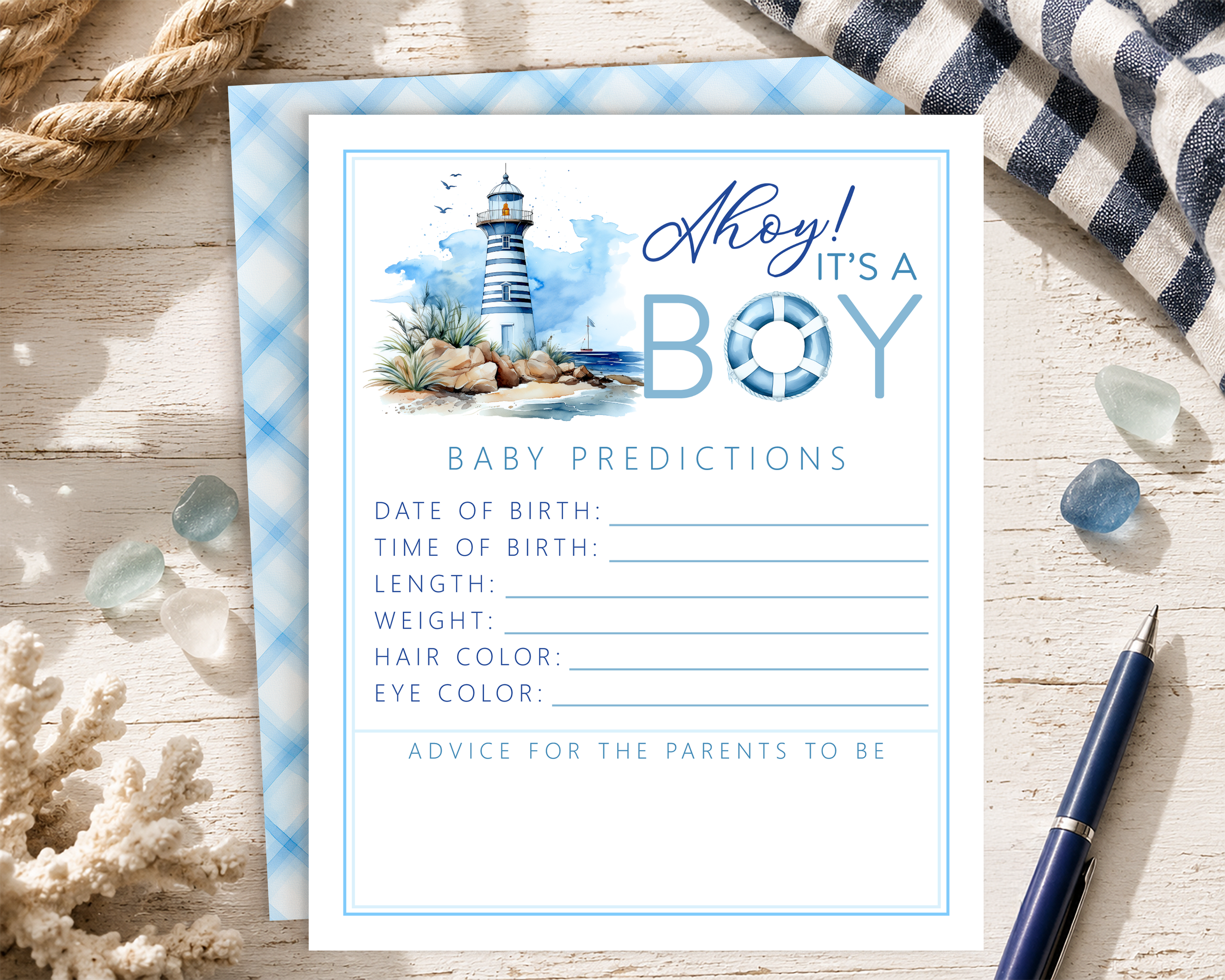 Nautical "Ahoy It's a Boy" baby predictions card with matching plaid backing displayed on a coastal tabletop with rope, coral, sea glass, and pen.