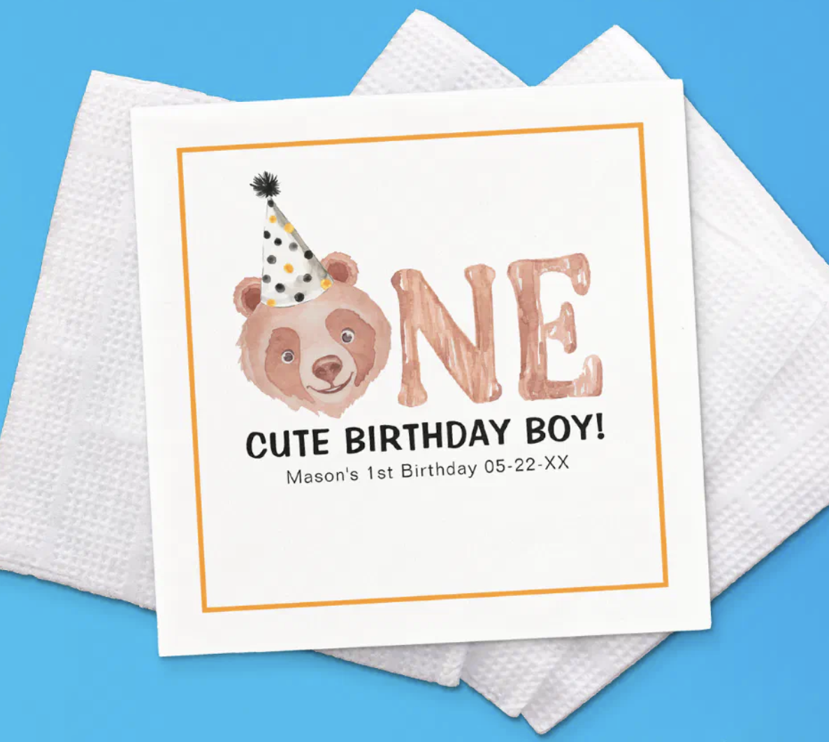 Teddy bear themed birthday napkins with “Two Years Old & Twice As Cute” lettering and soft neutral colors.
