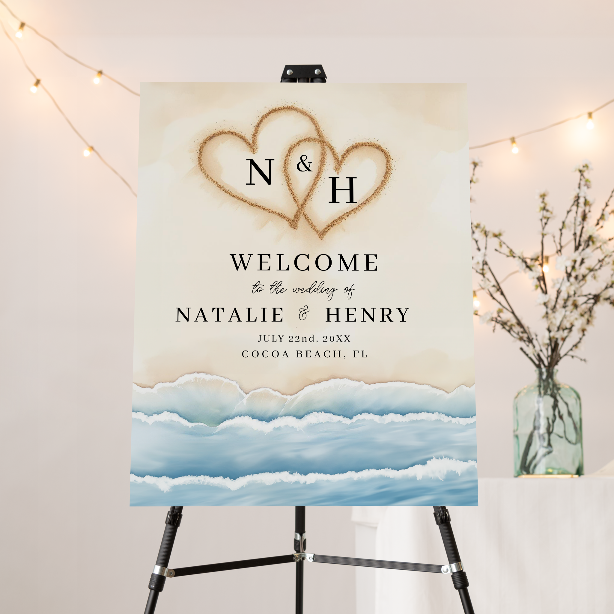 Beach wedding welcome sign with sand hearts and ocean-inspired watercolor