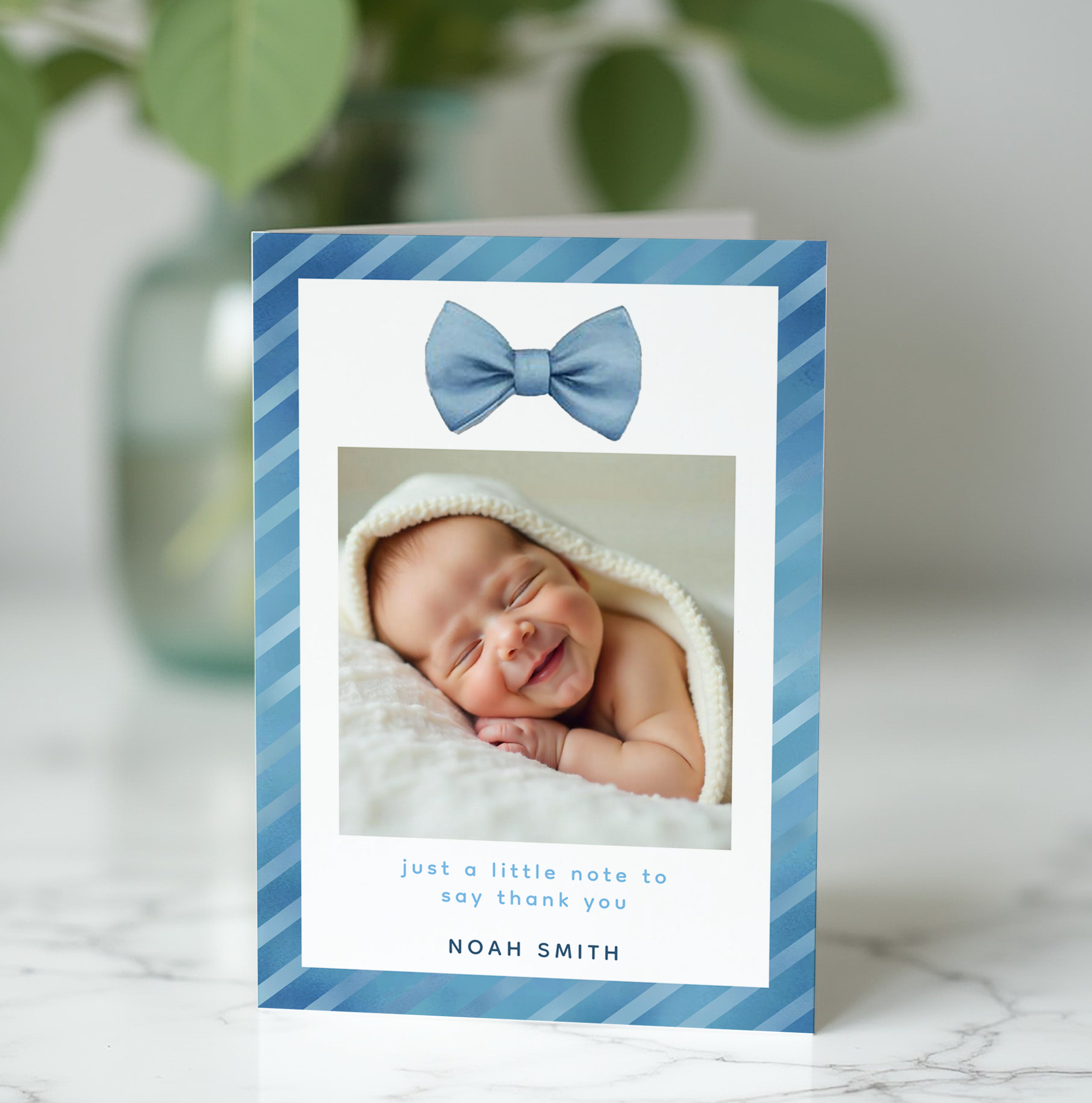 Blue bow tie baby shower photo thank you card with baby picture and soft striped border design.