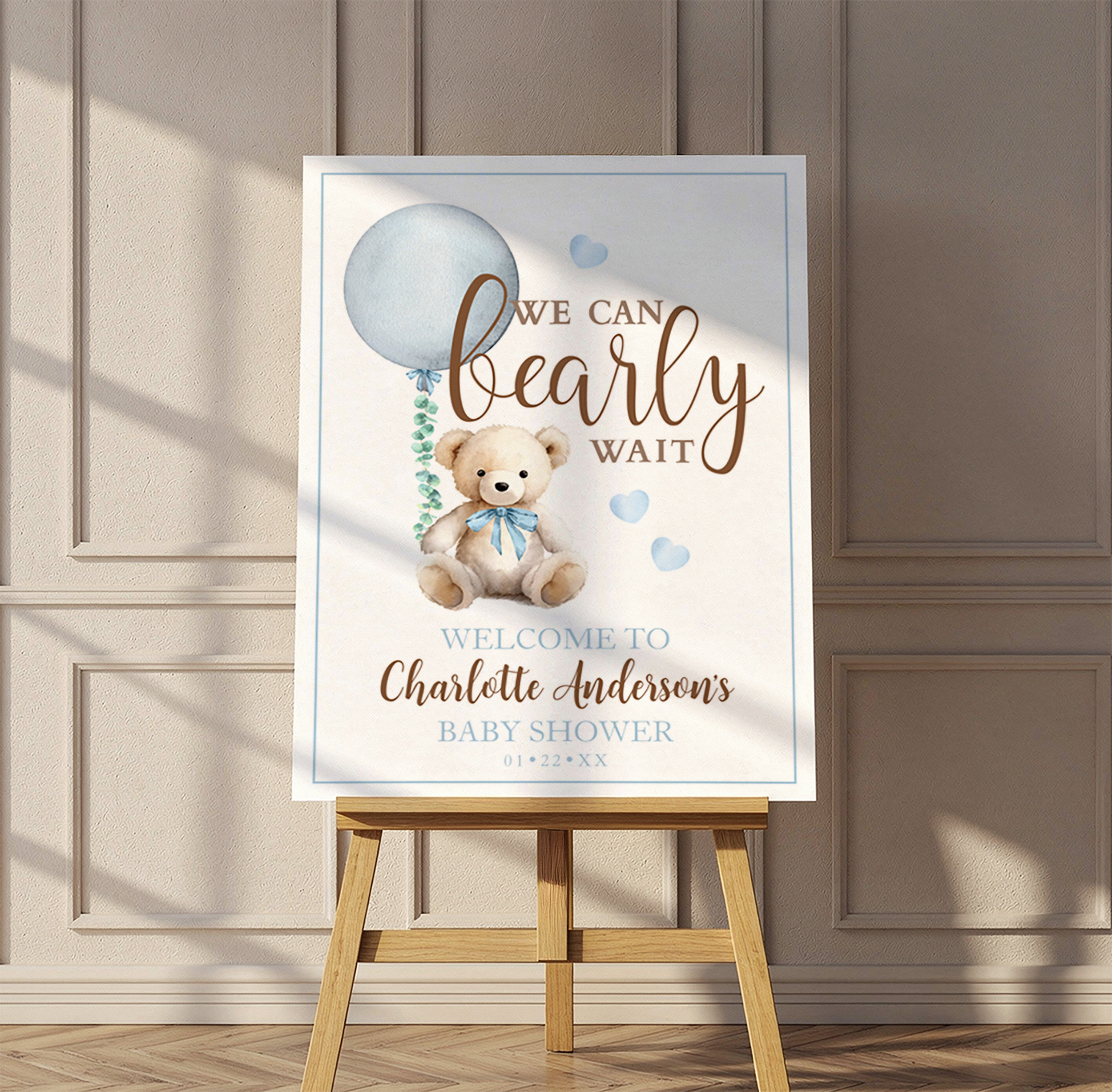 Blue teddy bear baby shower welcome sign with watercolor balloon and “We Can Bearly Wait” theme.