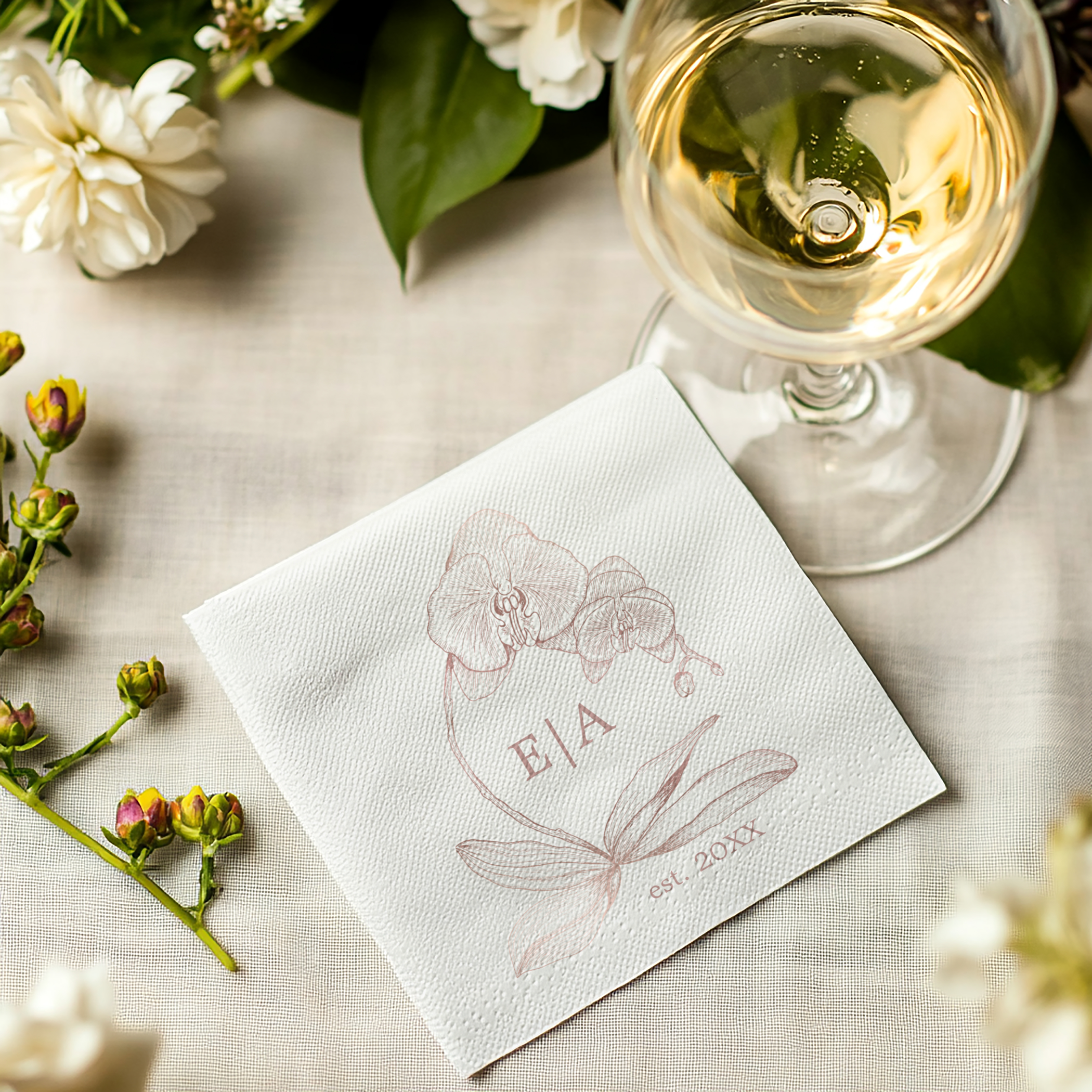 Personalized orchid monogram wedding cocktail napkins in soft dusty rose tones.