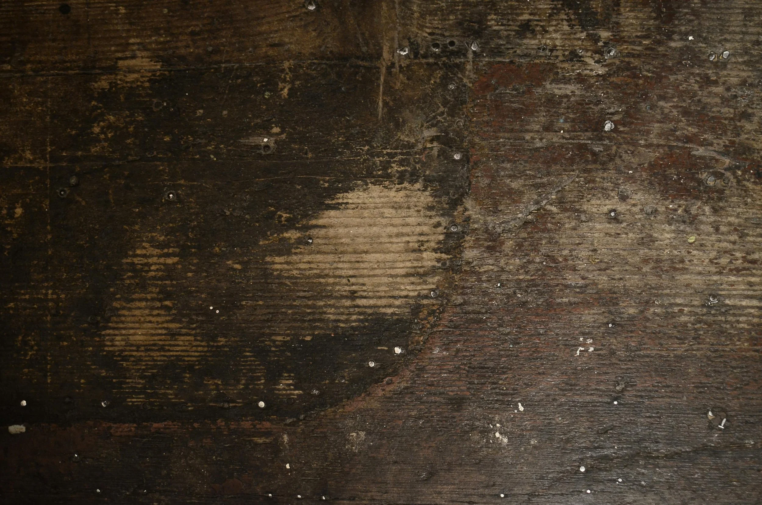 Weathered wood board texture background with dark tones, suggesting investigative and professional themes for Brannen Investigations