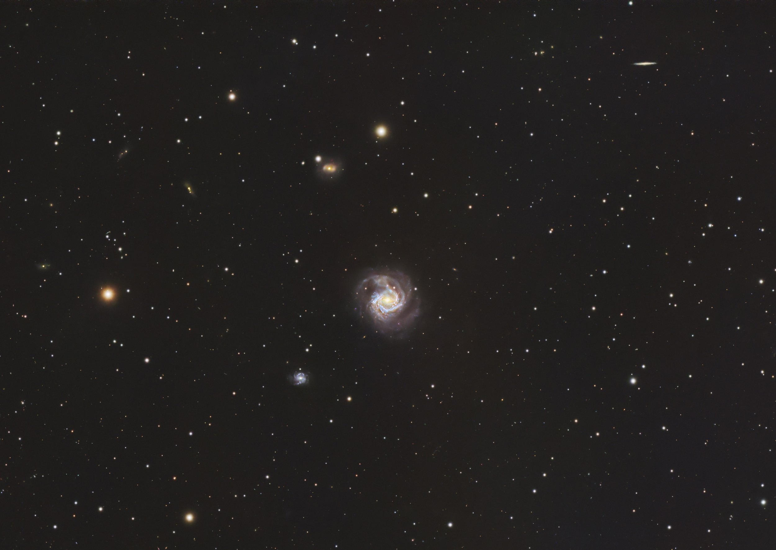A vast view of outer space filled with numerous stars and galaxies, showing bright and faint celestial objects.