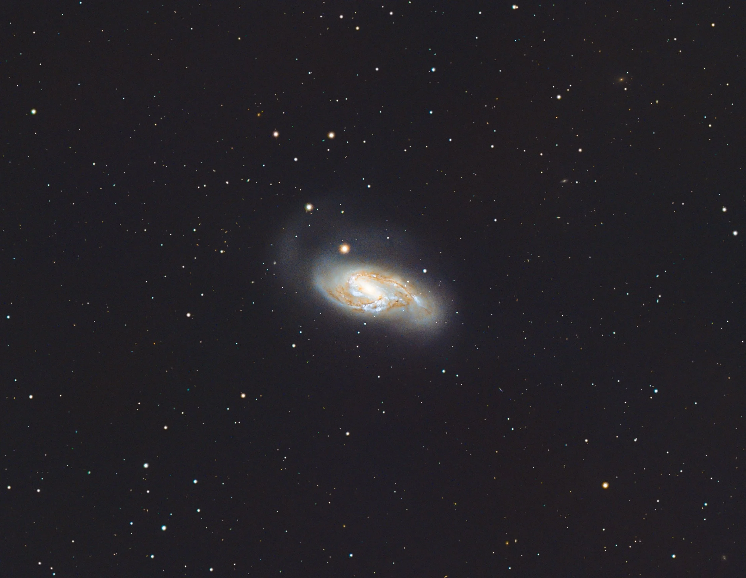 A galaxy with bright stars and a glowing core against a dark space background.