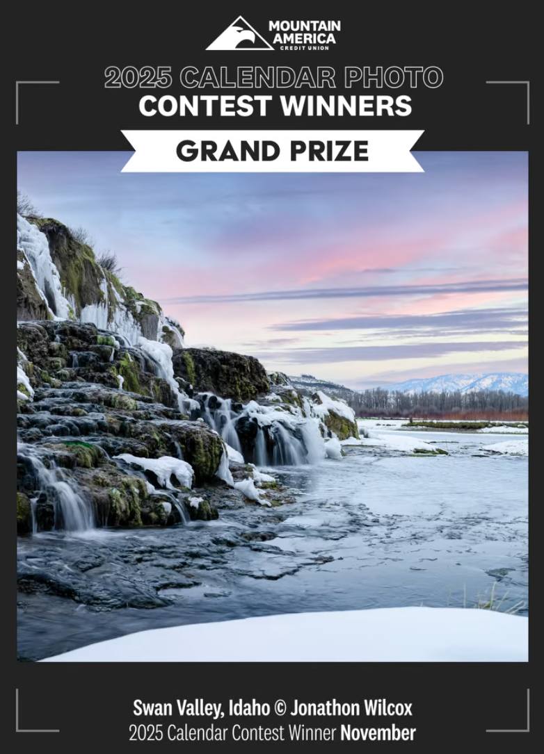 Cover of 2025 calendar photo contest winner with a landscape photo of a waterfall in Swan Valley, Idaho, featuring snow and a colorful sky. Text indicates Grand Prize winner, November, and credits Jonathon Wilcox.