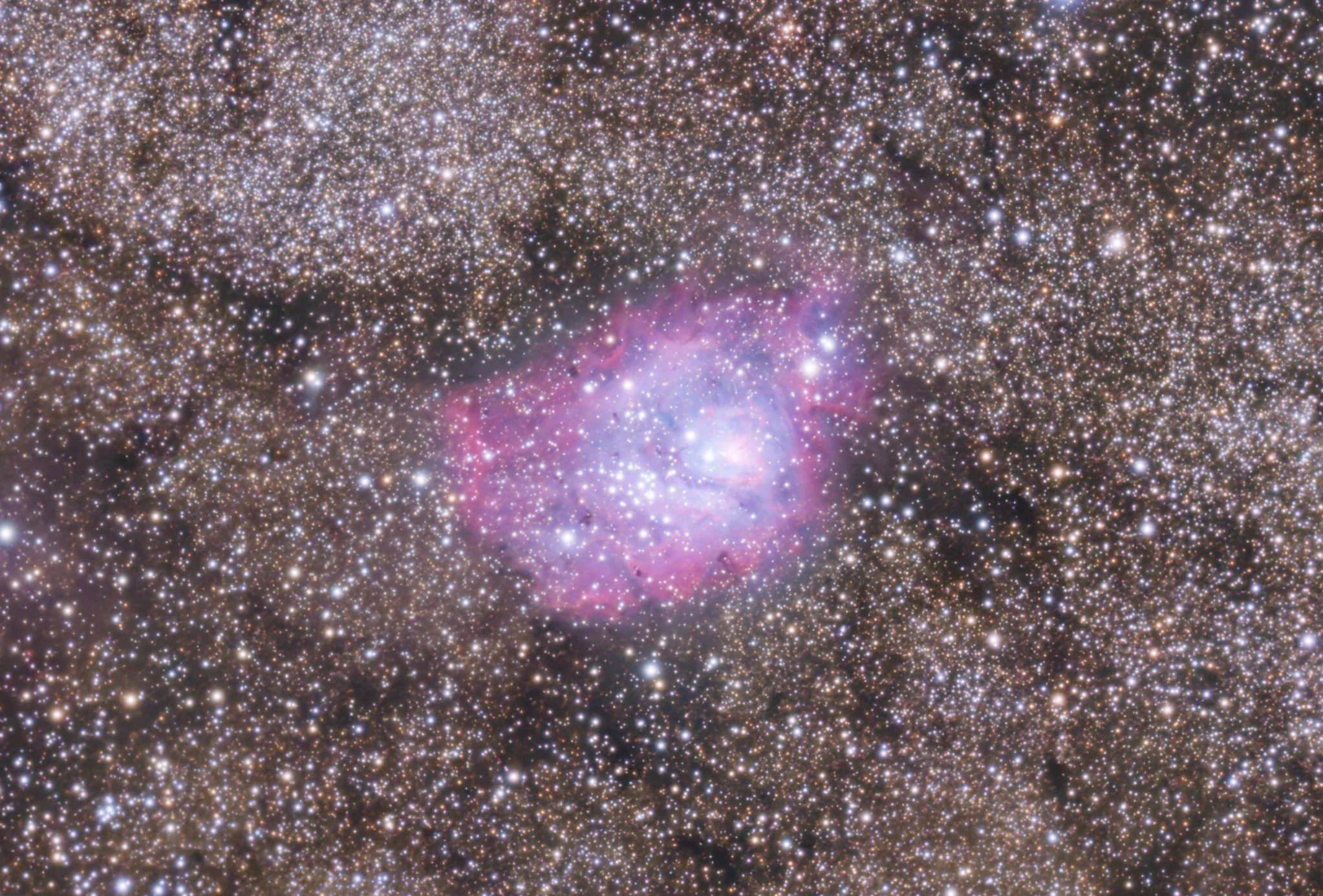 A detailed image of a star-filled region of space, showing numerous stars and colorful nebulae.