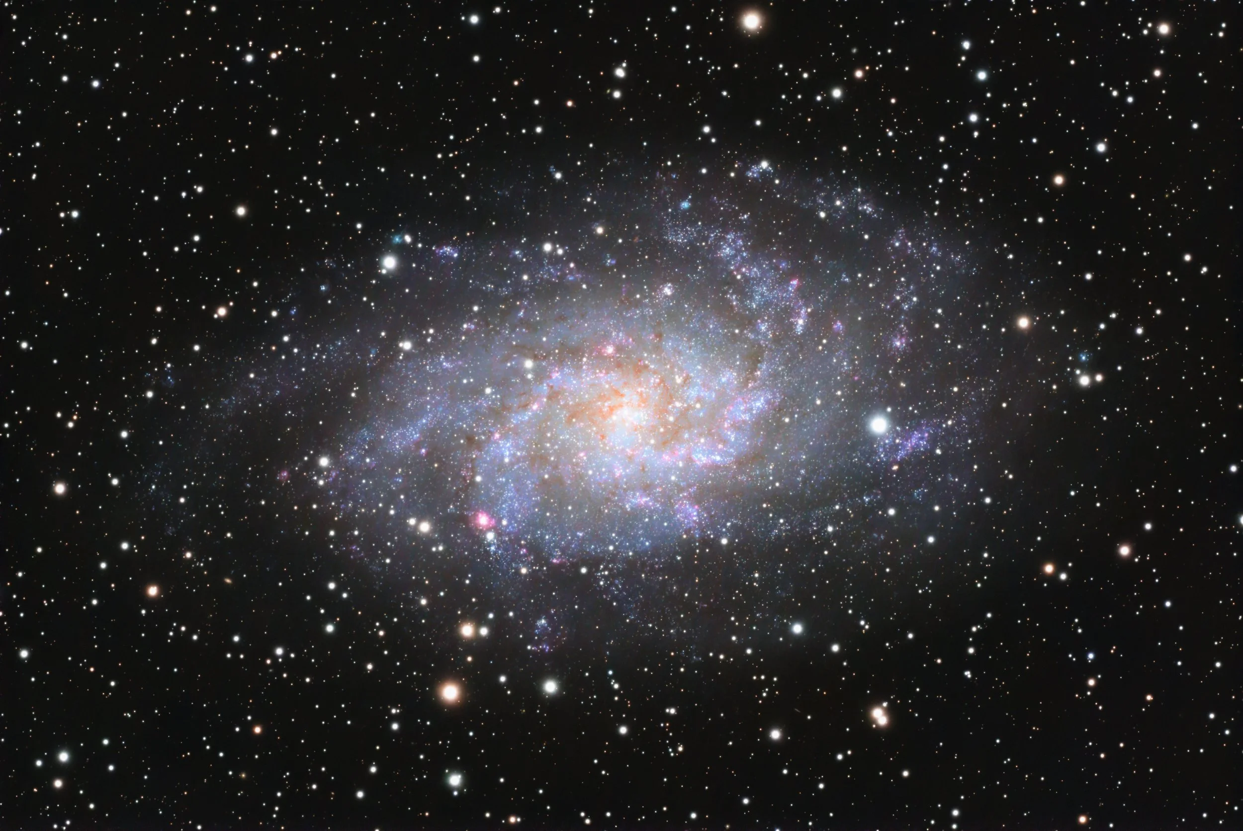 A detailed image of a galaxy with numerous stars and cosmic dust clouds against a black space background.