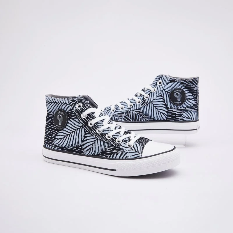 A pair of high-top sneakers with a black and white leaf pattern design, white laces, and a white rubber sole.