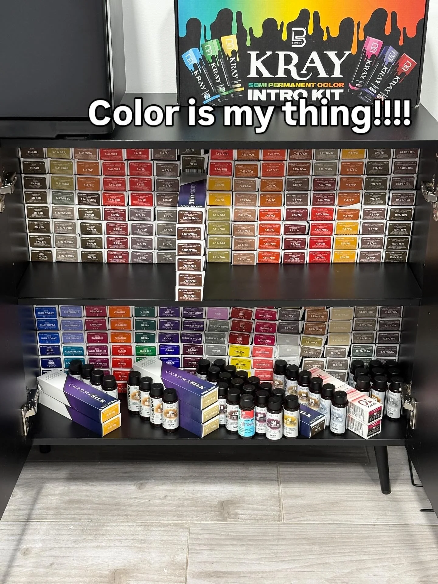 A display cabinet of semi-permanent hair color products, including color boxes and bottles, with the top box labeled 'KRAY'.