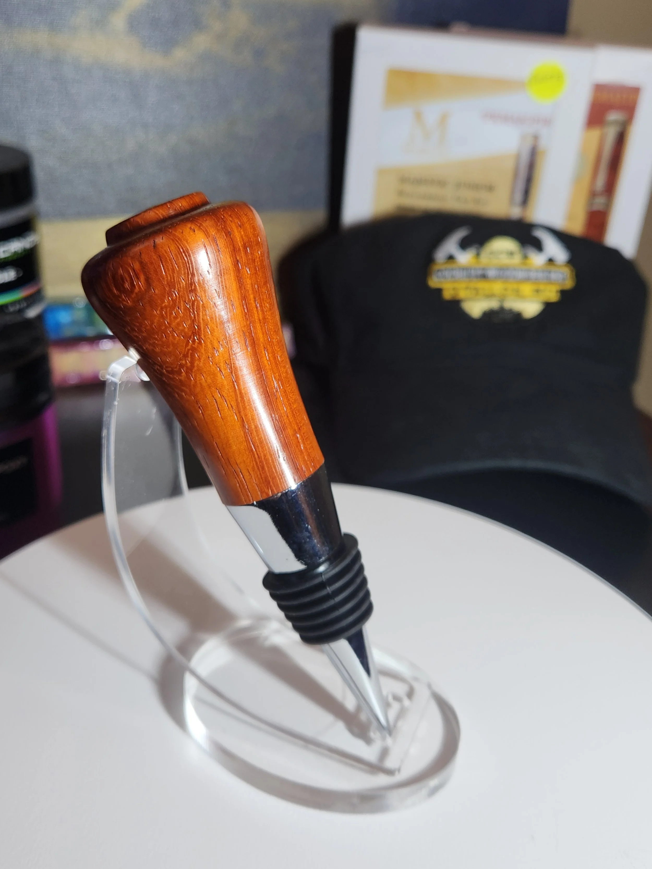 A pen with a wooden handle on a white surface.