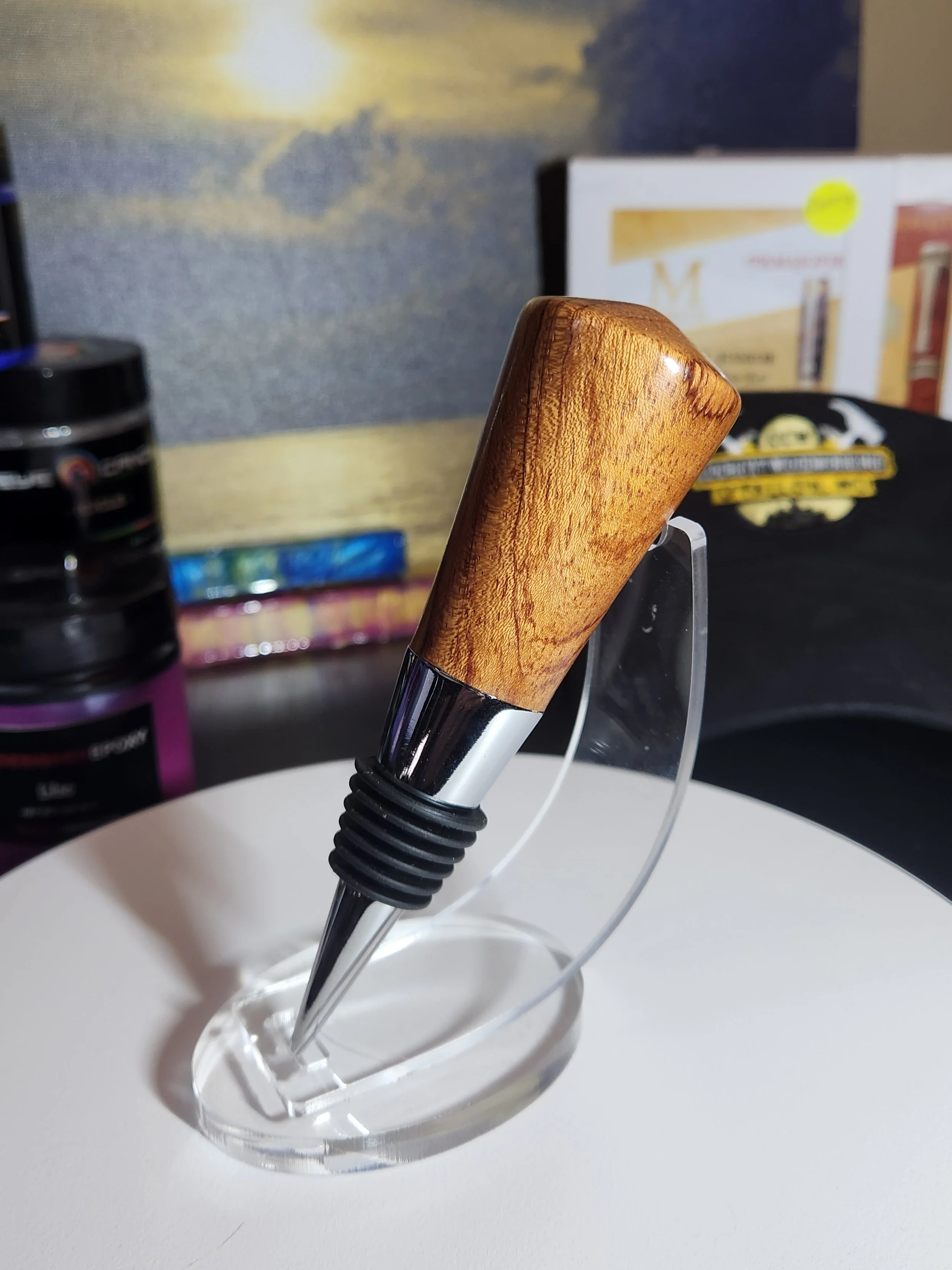 Close-up of a pen with a wooden handle on a white surface.