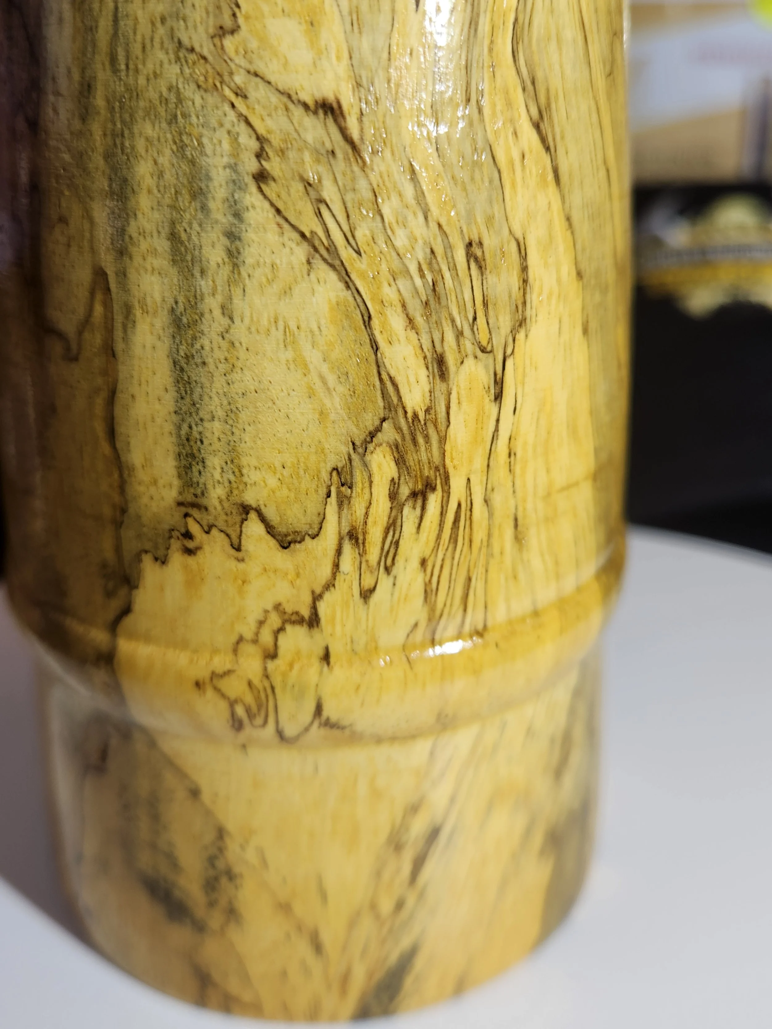 Close-up of a wooden object with a natural grain pattern and polished surface.