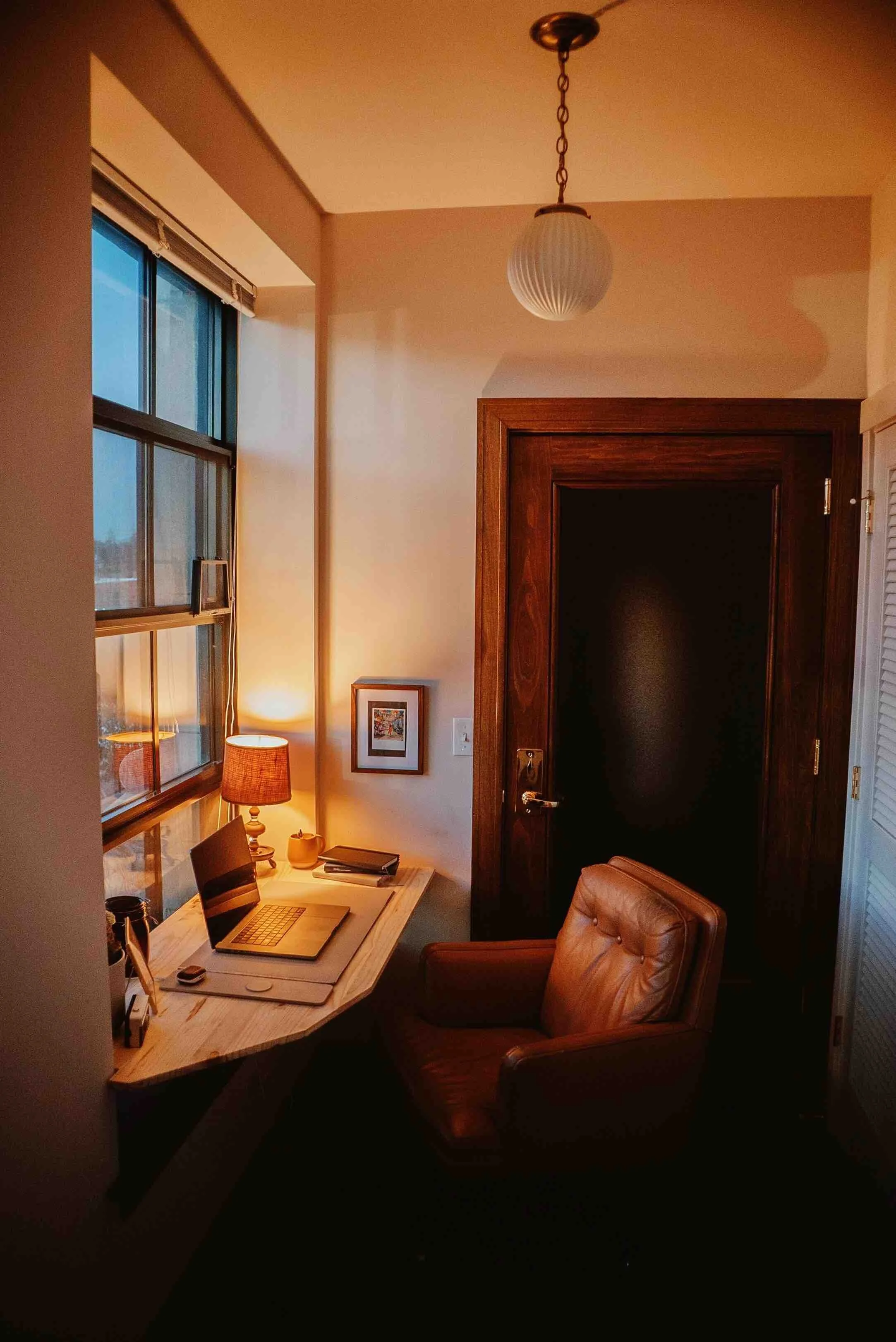 Office with an orange leather chair and laptop. Office for online therapy in Chapel Hill, Raleigh, Asheville, Charlotte, NC