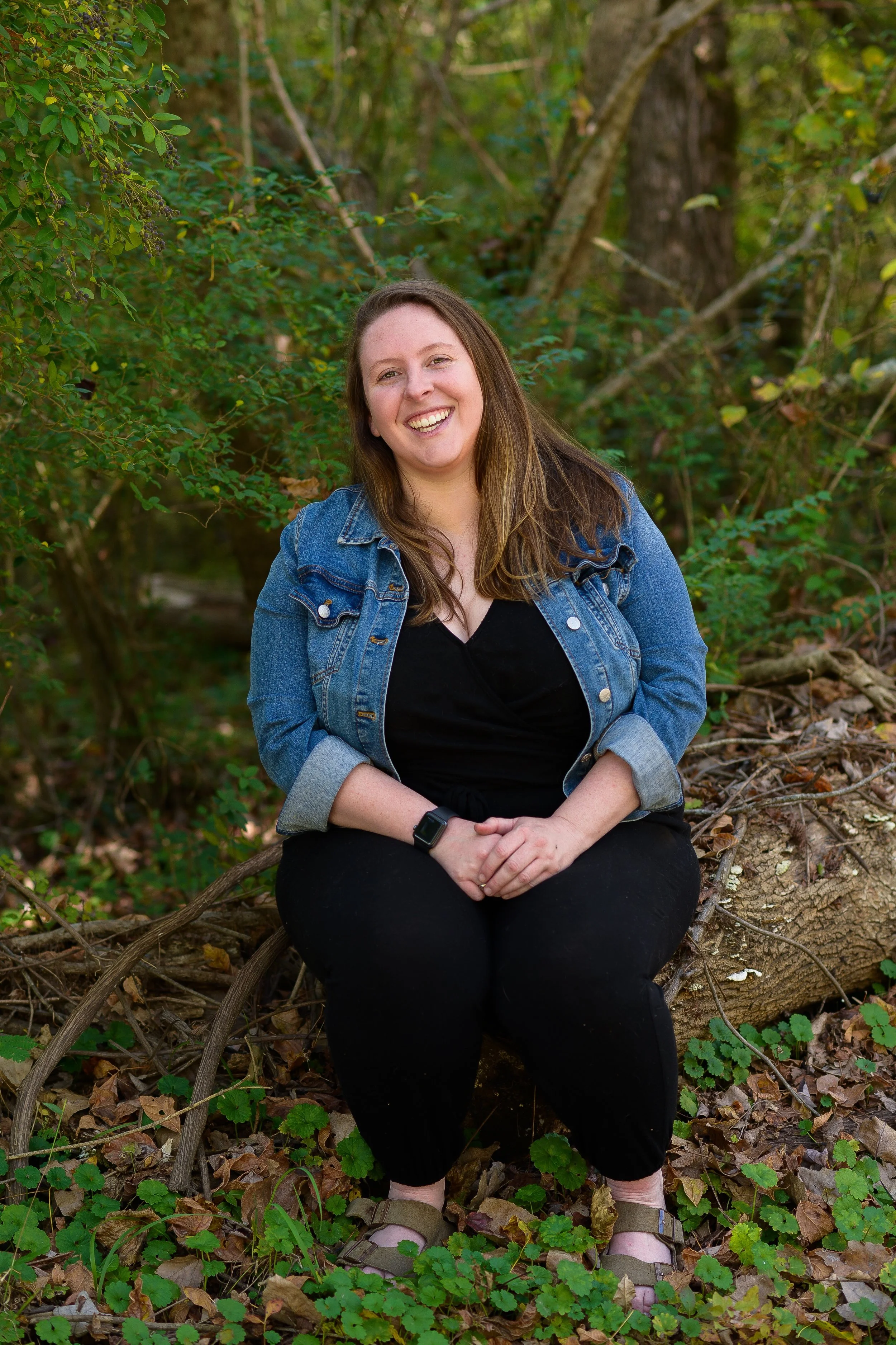 Brunette woman in jean jacket. An anxiety therapist Katie Hargreaves offering anxiety therapy in Durham and Chapel Hill, NC