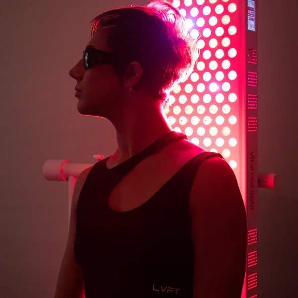 A person standing in front of the Vital Red light