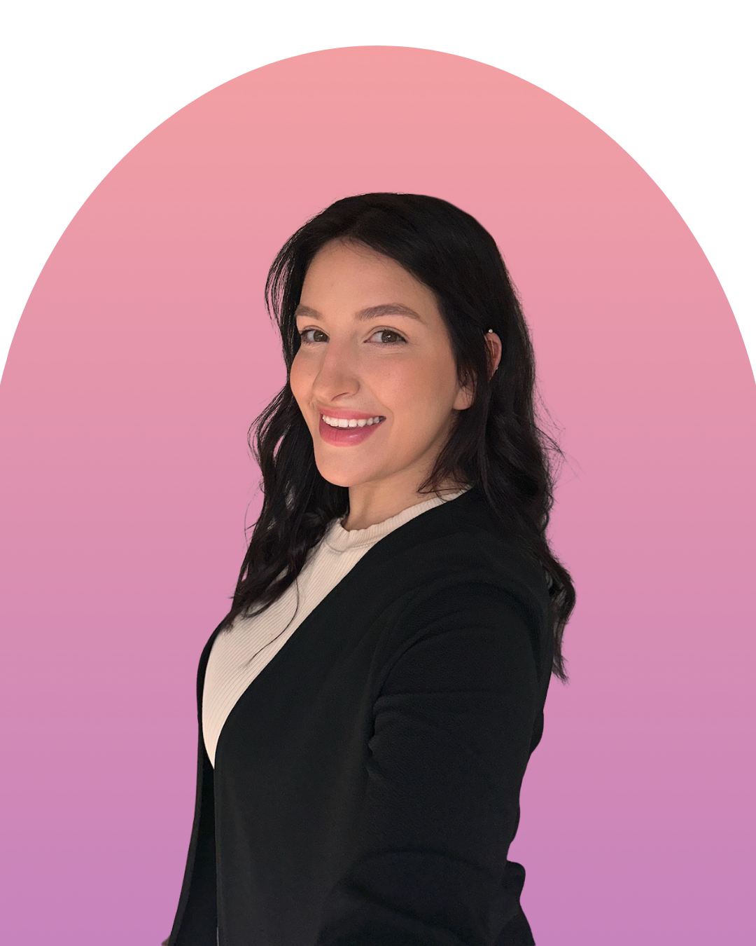 A woman with black hair, wearing a black blazer over a white top, smiling against a pink background with a white arch.