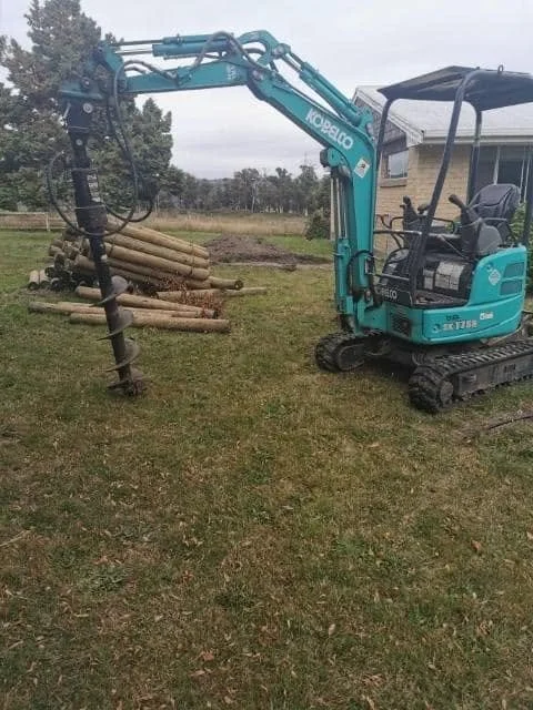 Phillip Holmes using MEB Hire excavator auger for post holes