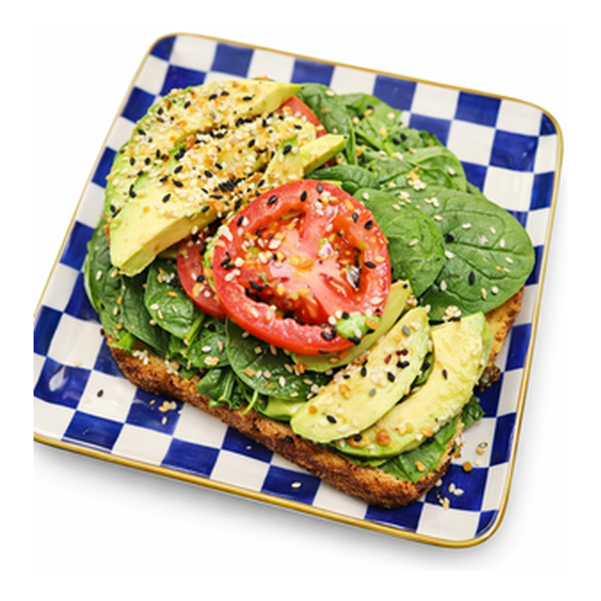 Avocado toast topped with spinach, tomato and seasoning