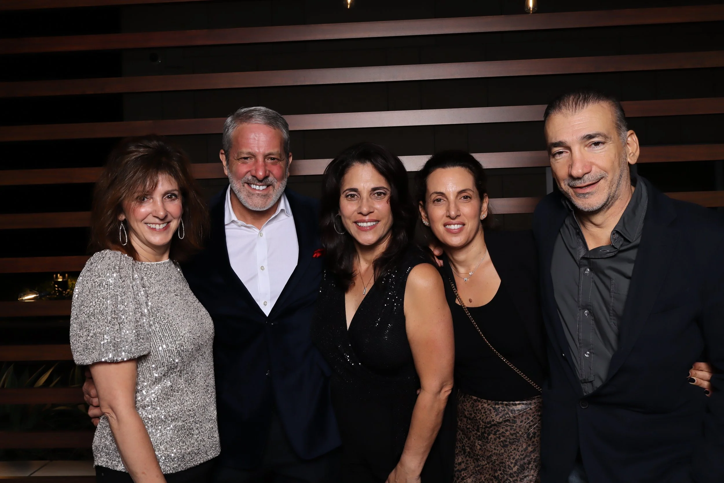 Corporate Christmas party photo booth rental at Life Time Fitness in Palm Beach Gardens with wooden wall and holiday accessories