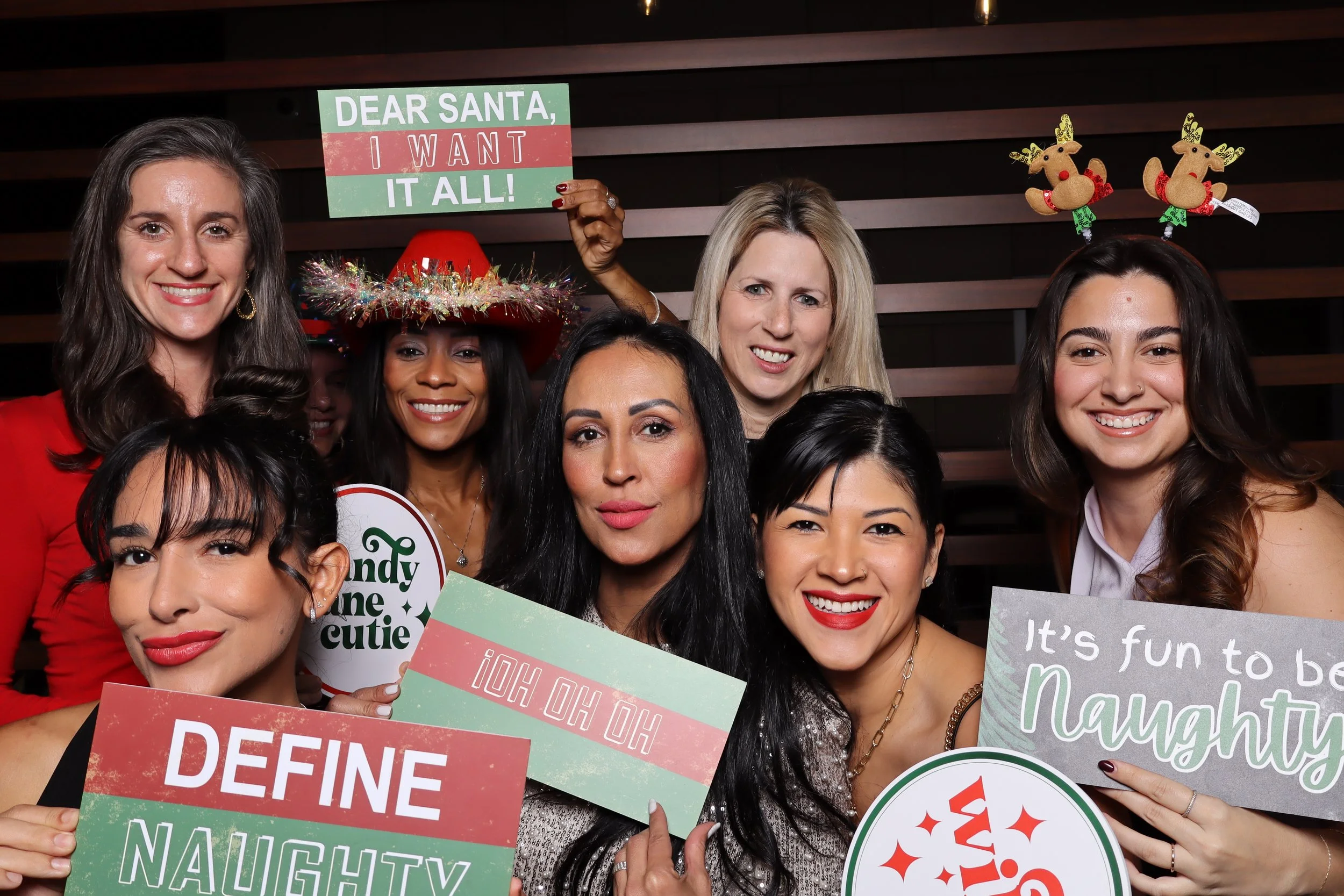 Luxury corporate Christmas photo booth experience at Life Time Fitness in Palm Beach Gardens with wooden wall backdrop and festive holiday props by AdCole Events