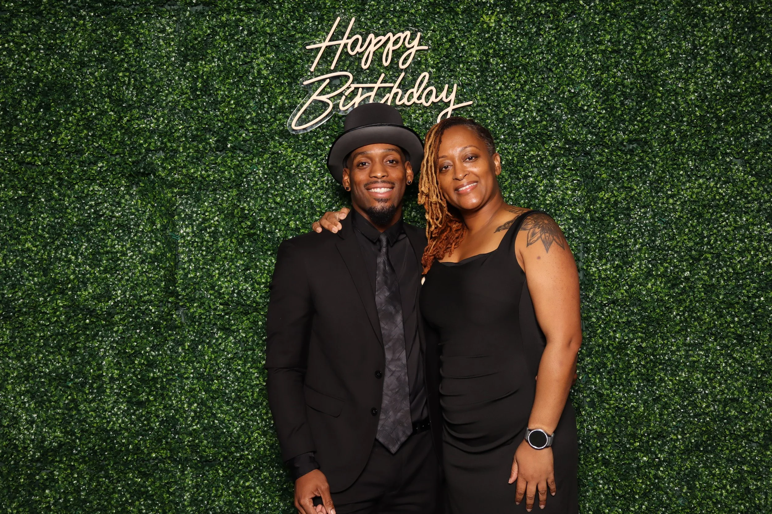 Luxury birthday photo booth experience with green hedge wall and “Happy Birthday” sign at Jacaranda Golf Club in Plantation, FL by AdCole Events