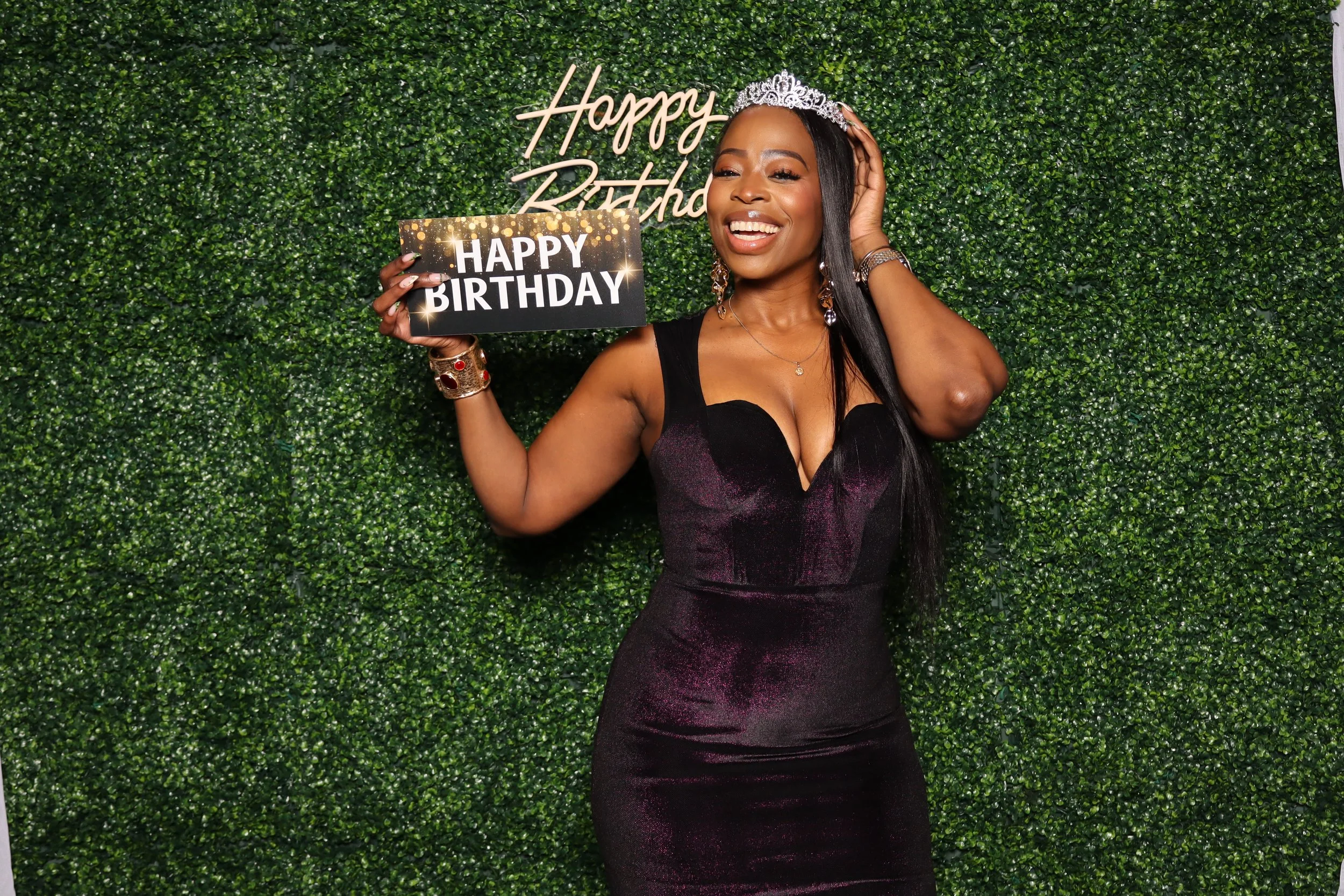 Birthday photo booth rental at Jacaranda Golf Club in Plantation, FL with green hedge wall and “Happy Birthday” sign